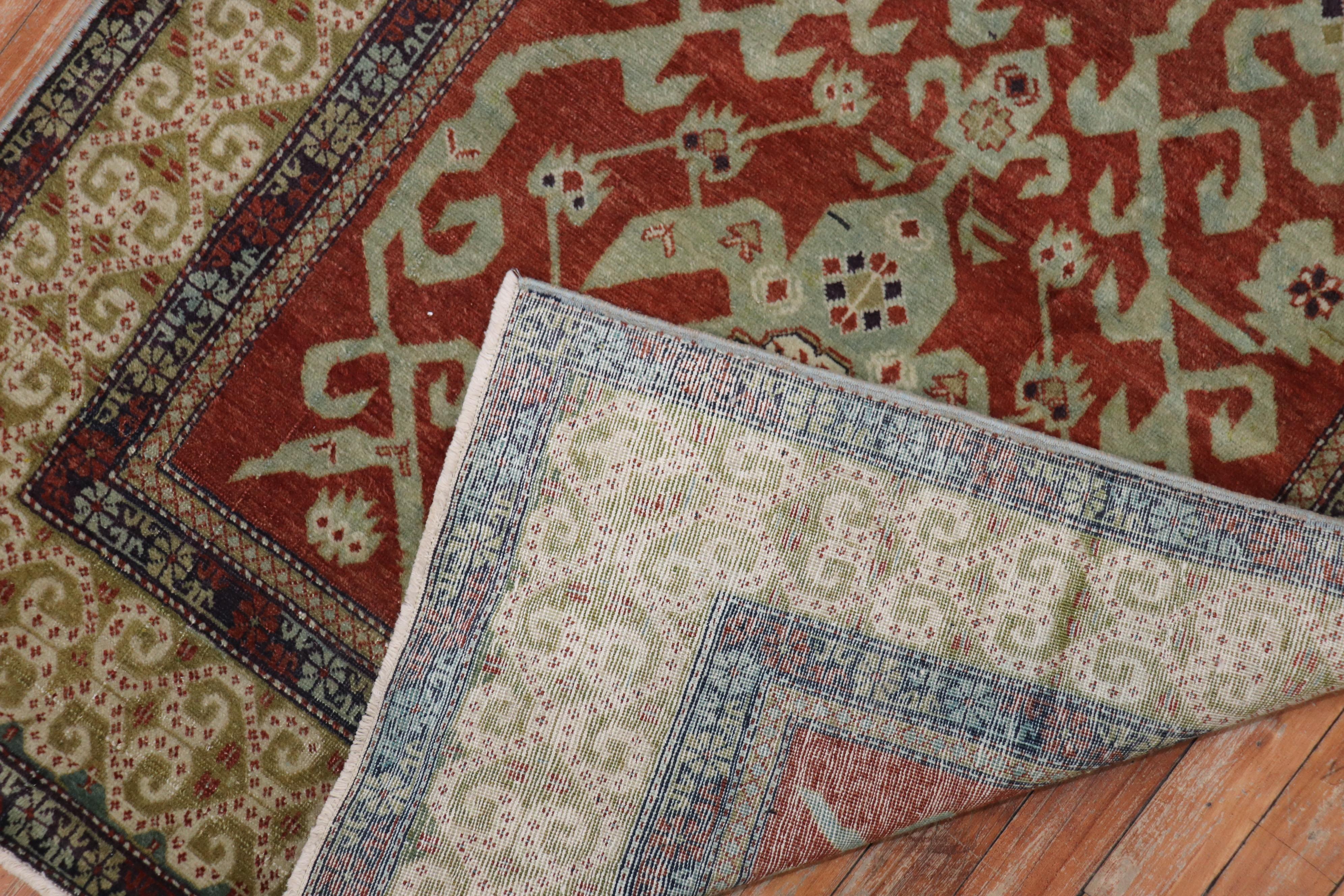 A geometric Caucasian shirvan rug from the early 20th century.
Brick red field, earth accents in green and blue,

circa 1910. Measures: 3'1