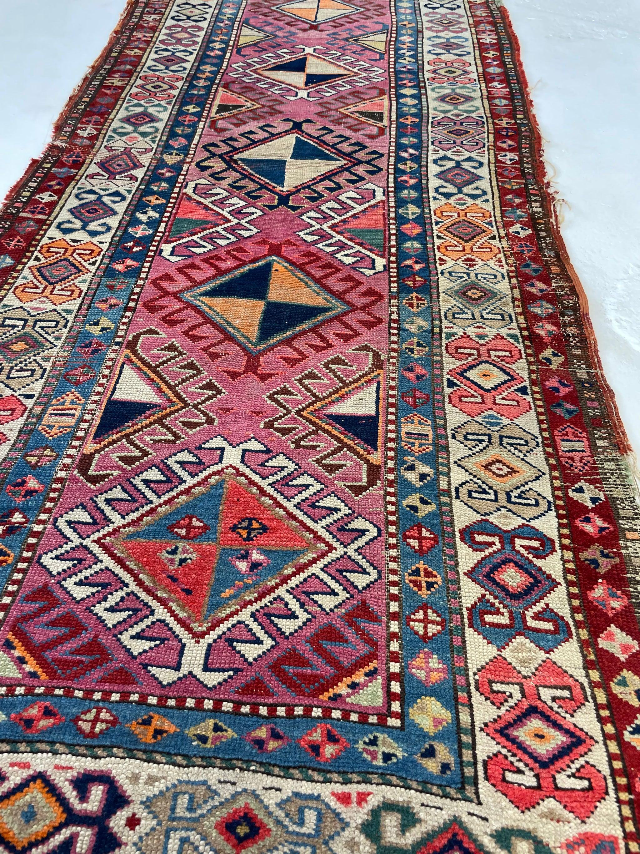 Maybe the Most Beautiful runner Ever? Sunset Colors Antique Caucasian Shield Medallion with Akimbo Border

About: Rare sunset color palette and just a true tribal village piece with geometric motifs throughout that are all different sizes and