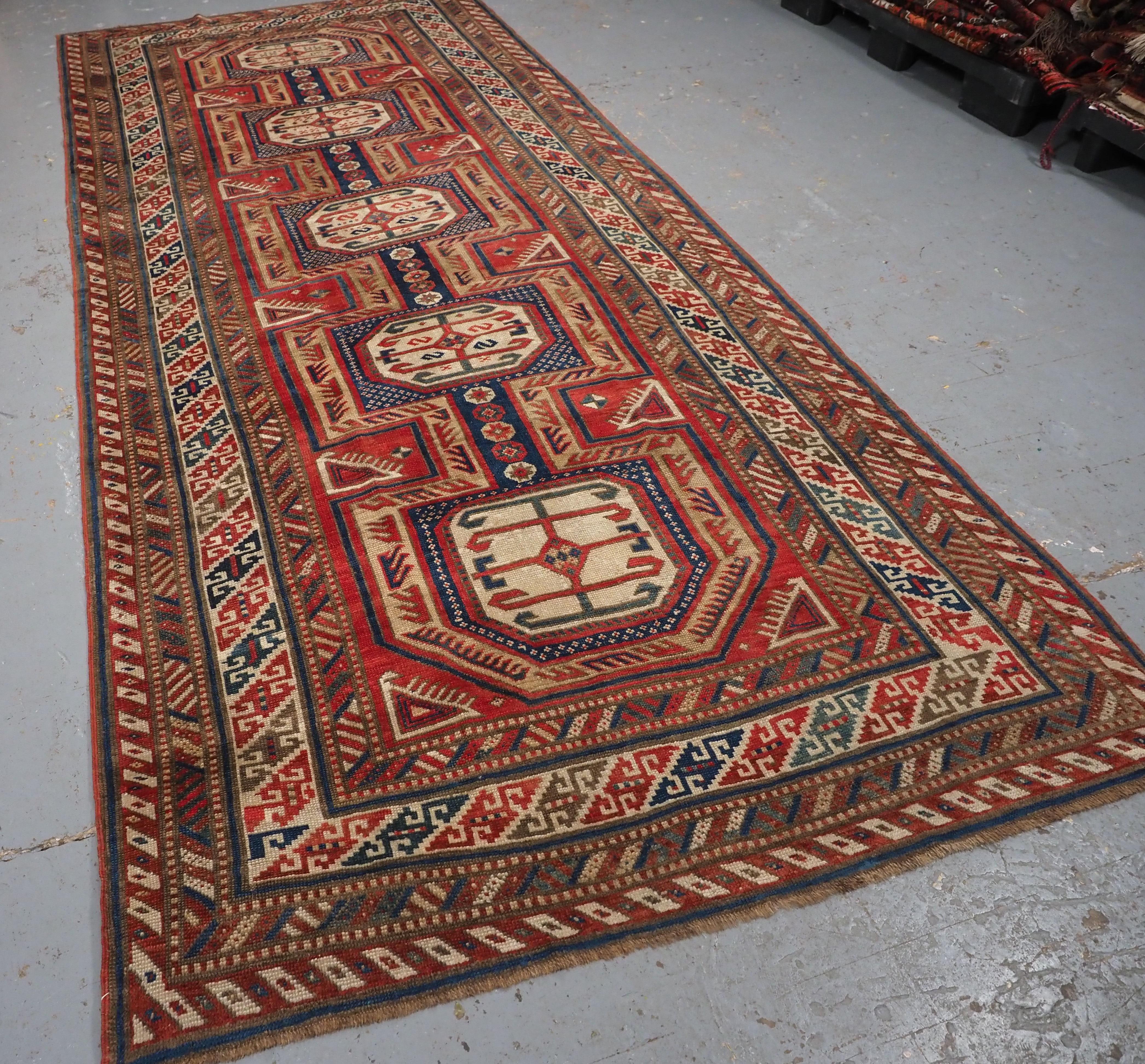 
Size: 10ft 11in x 4ft 8in (332 x 142cm).

Antique Caucasian Shirvan Baku long rug with 'Surahani' garden design.

Dated 1310 (1892).

A good example of a Shirvan rug, with the sought after garden design often associated with the village of