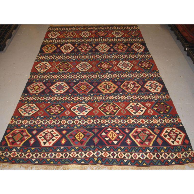 Antique South Caucasian Shirvan kilim of good colour and traditional banded design.

A very good example of a Shirvan kilim, with an indigo blue ground offsetting the medallions which are in a range of natural dyed colours. The kilim is of a