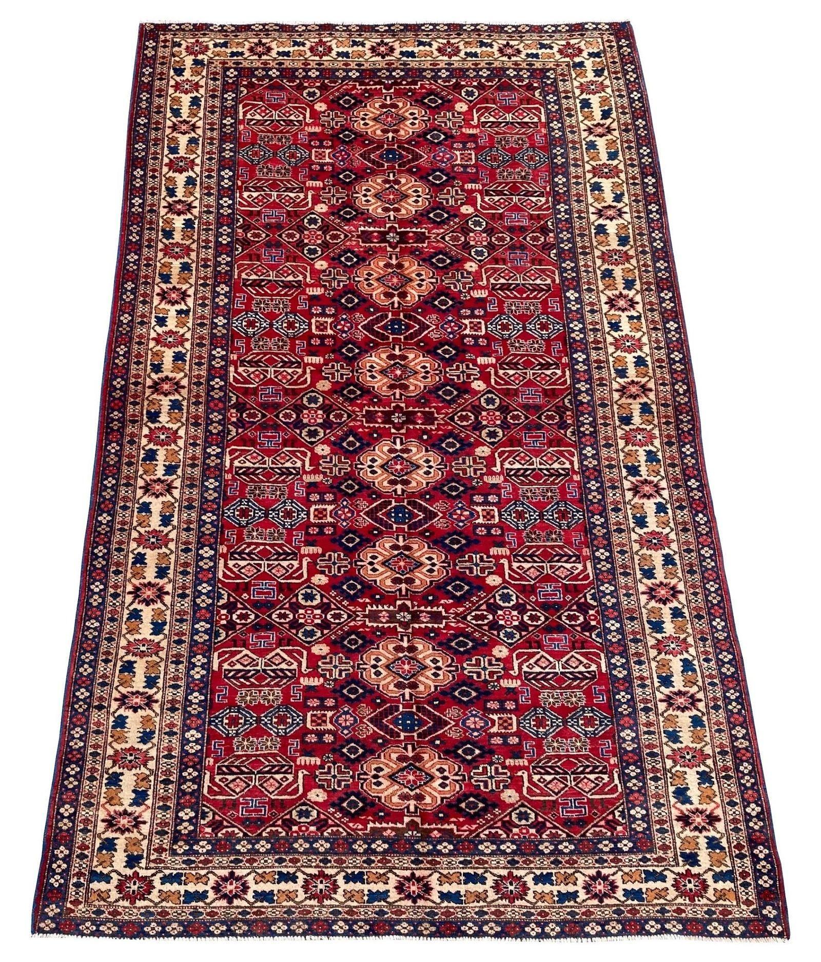 A beautiful antique Shirvan carpet, hand woven in the Caucasus mountains of south-east Azerbaidjan circa 1910 with a geometrical design of stylised flowers and birds on a rich red field and ivory border. Fabulous wool quality and great secondary
