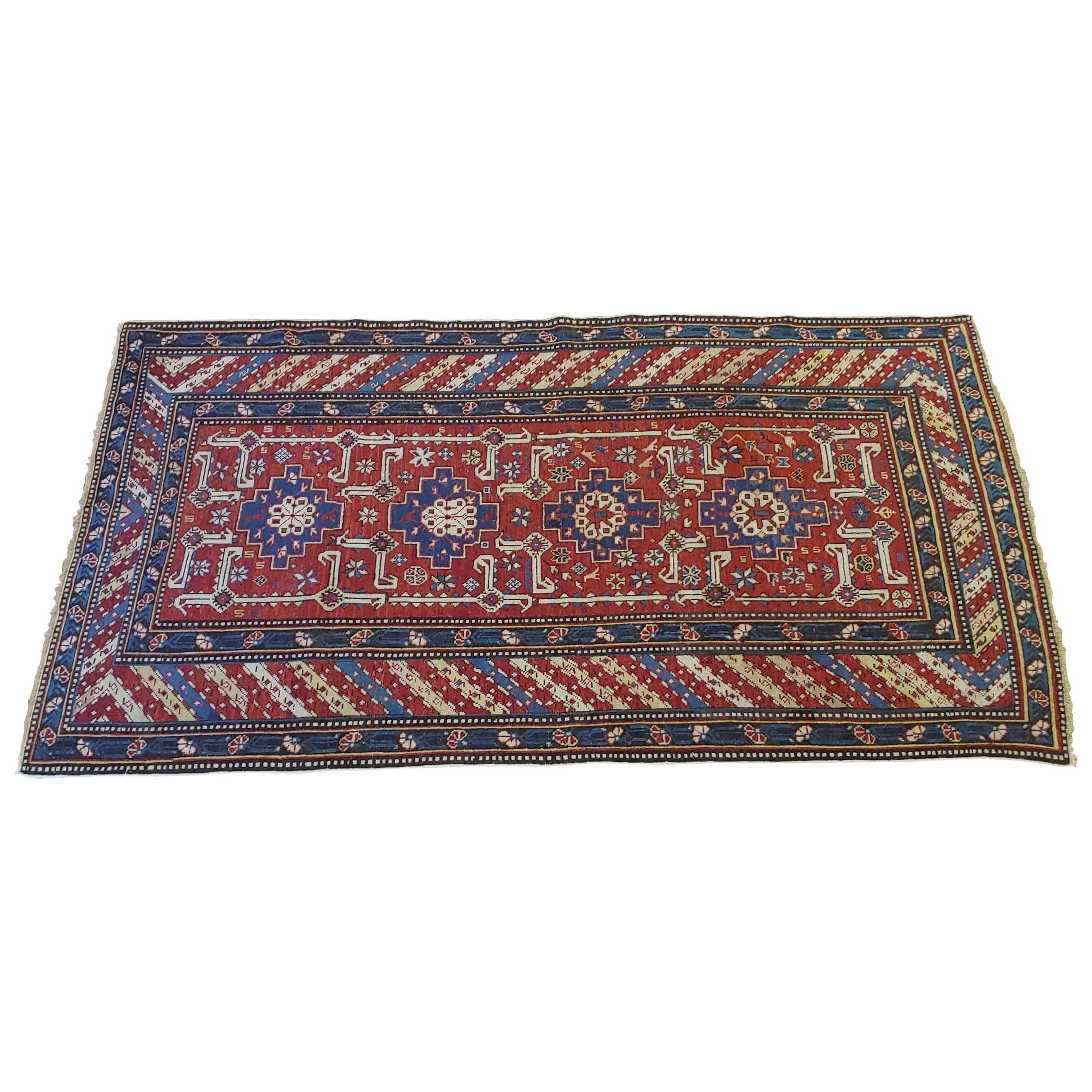 This is a Caucasian Shirvan rug with a lovely all-over geometric motif on a rust field with a striped border. It is circa 1900 and is a scatter size of 3-7 x 6-9.