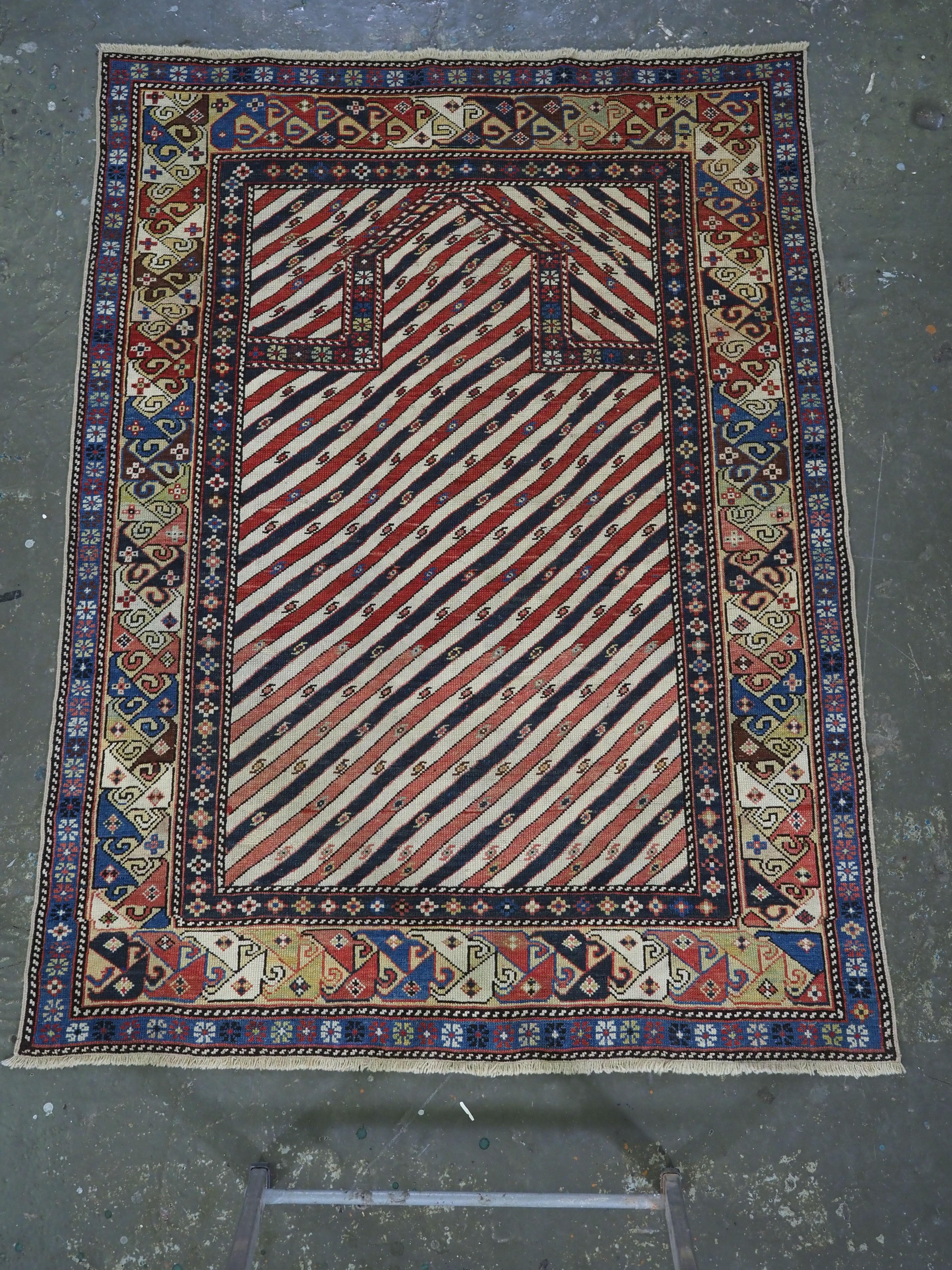 Size: 4ft 9in x 3ft 7in (145 x 109cm).

Antique Caucasian Shirvan or Dagestan prayer rug with scarce diagonal stipe design.

Circa 1870.

An outstanding example of this well documented group of prayer rugs, this rug is very will drawn with diagonal