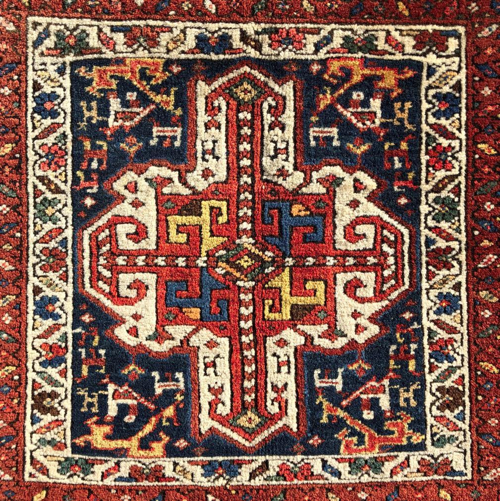 Antique Caucasian Shirvan Kabistan rug, District of Shemaka, Russian Empire. A fine vegetable dyed wool pile knotted on a cotton foundation. A Kaikalak medallion on center of white and orange on a dark blue field framed by three floral meander
