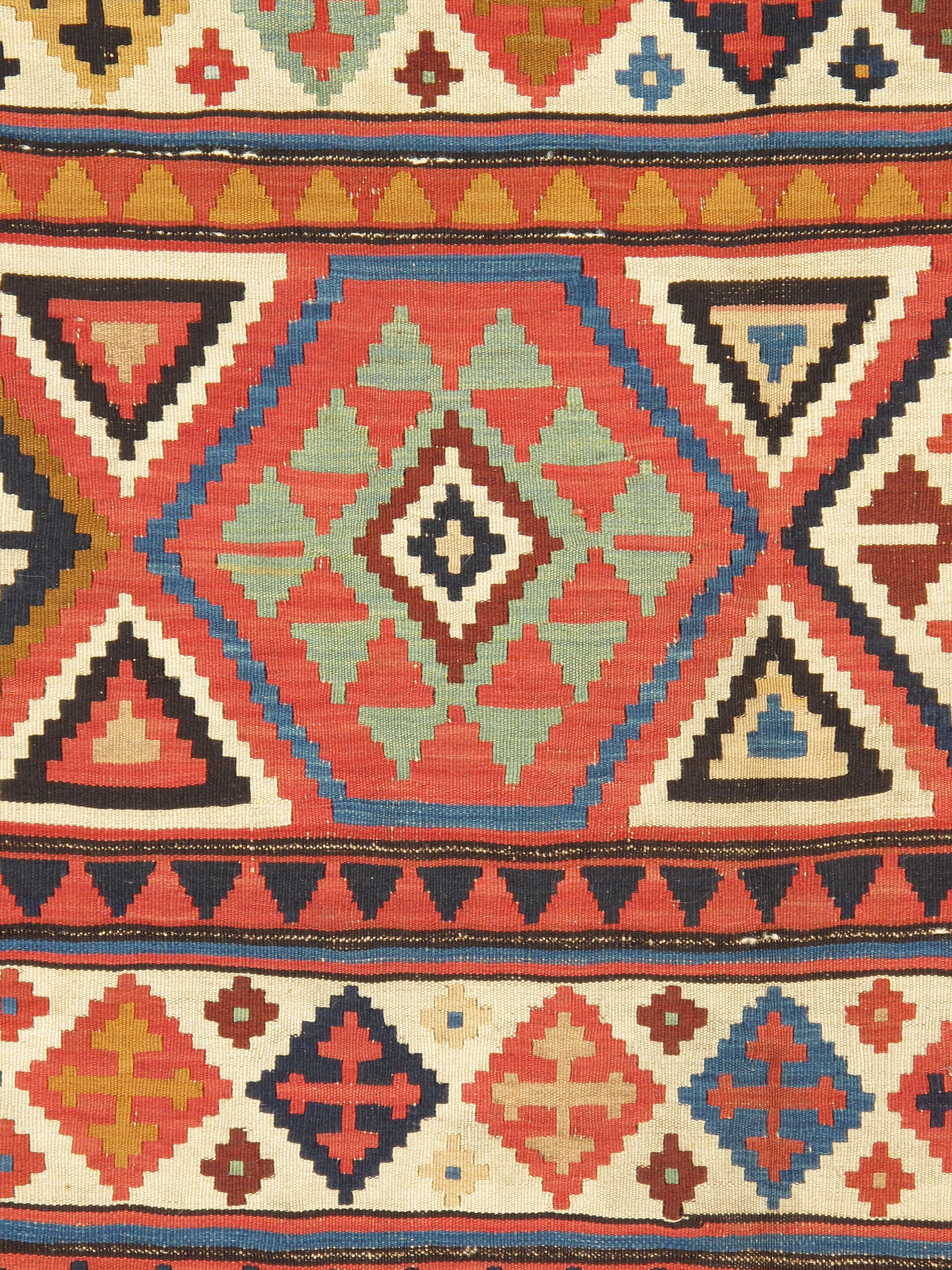 Antique Caucasian Shirvan Kilim.  Size: 5'1 x 9'6. This is a Kilim weave (slit tapestry) flat-woven small carpet from the Shirvan area in a pattern absolutely characteristic of the group. Wide and narrower horizontal bands alternate with stepped