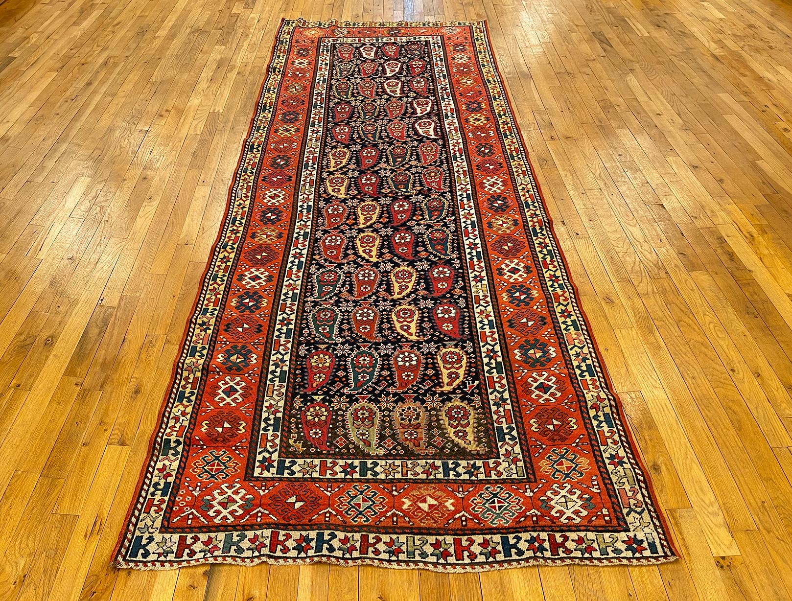 Antique Caucasian Shirvan rug, runner size, circa 1890.

A one-of-a-kind antique Caucasian Shirvan Oriental Carpet, hand-knotted with soft wool pile. This lovely rug features a Paisley design allover the blue primary field, with an attractve coral