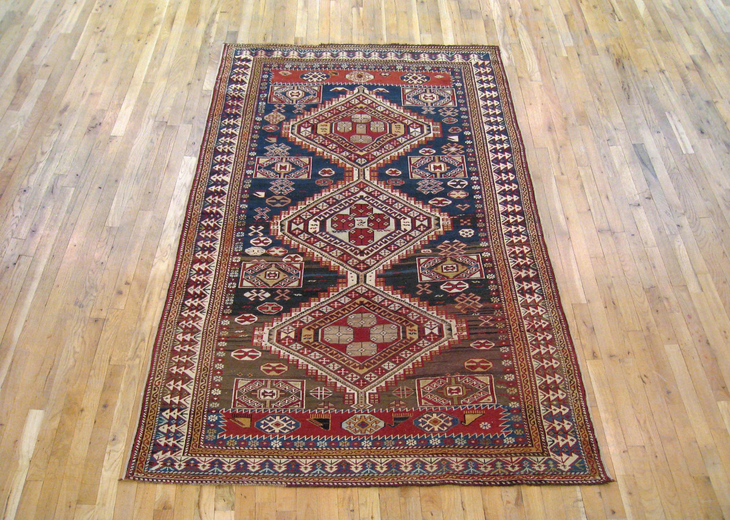 Antique Caucasian Shirvan rug, Small size, circa 1890

A one-of-a-kind antique Caucasian Shirvan Oriental Carpet, hand-knotted with soft wool pile. This lovely hand-knotted carpet features multiple medallions with a diamond design on the brown