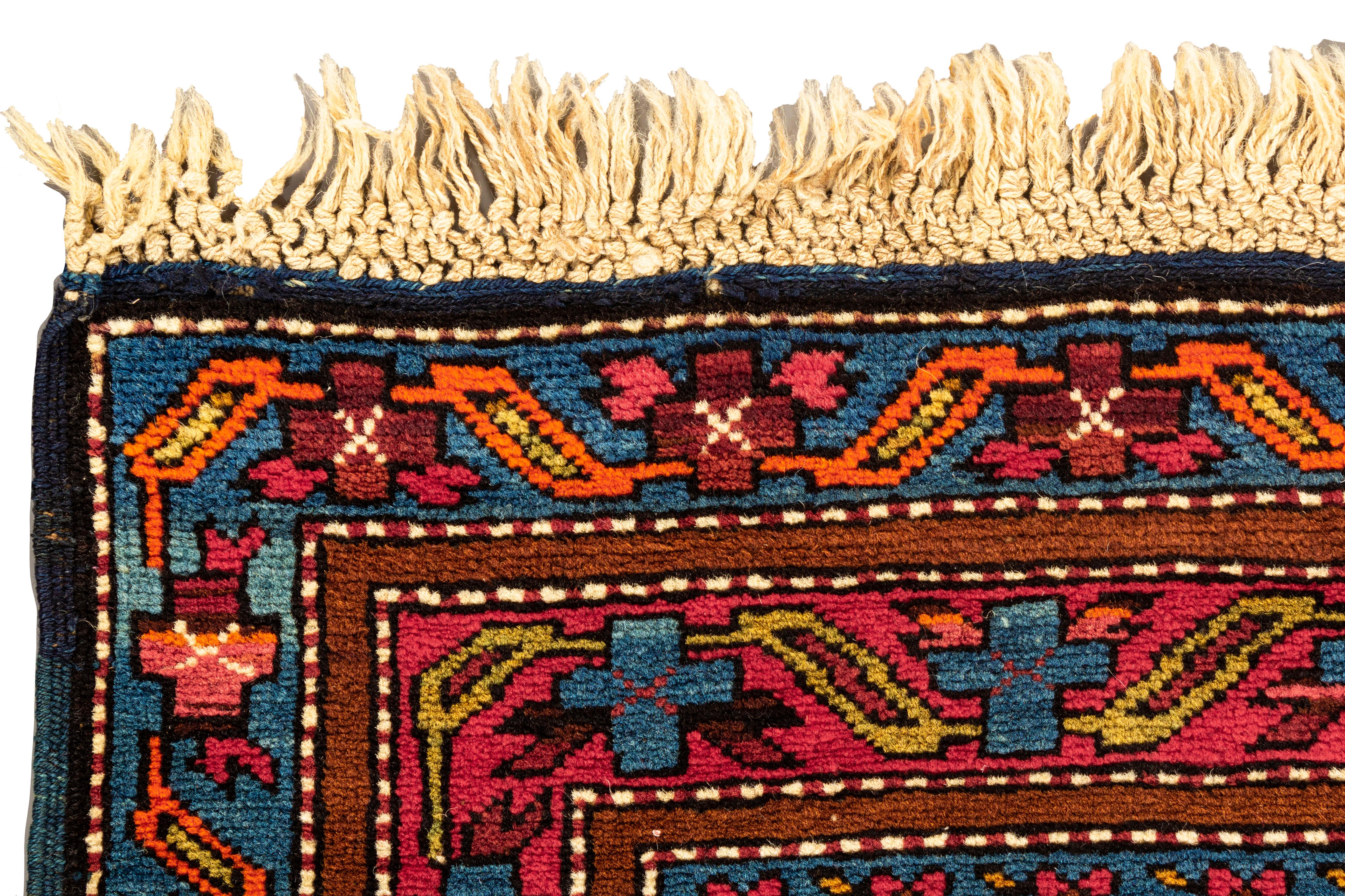 Antique Caucasian Shirvan Rug circa 1880. From east Caucasia a Shirvan handwoven rug circa 1880, with bold and vibrant colors, that create a true sense of beauty, to this tribal rug. The central blue field is filled with wonderful primitive designs,