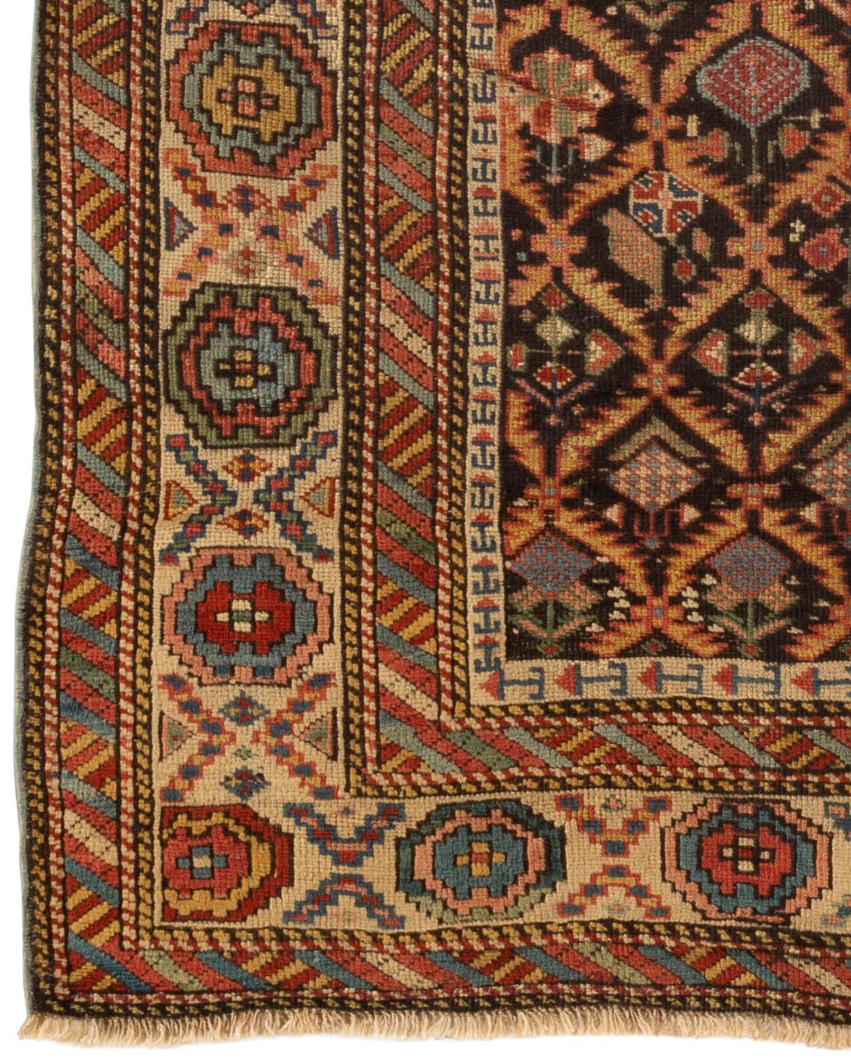 Antique Caucasian Shirvan rug, circa 1880. The navy field divided into diamonds enclosing flower heads within traditional Shirvan multiple borders framing the rug. These types of antique Caucasian rugs were woven in the eastern part of the region,