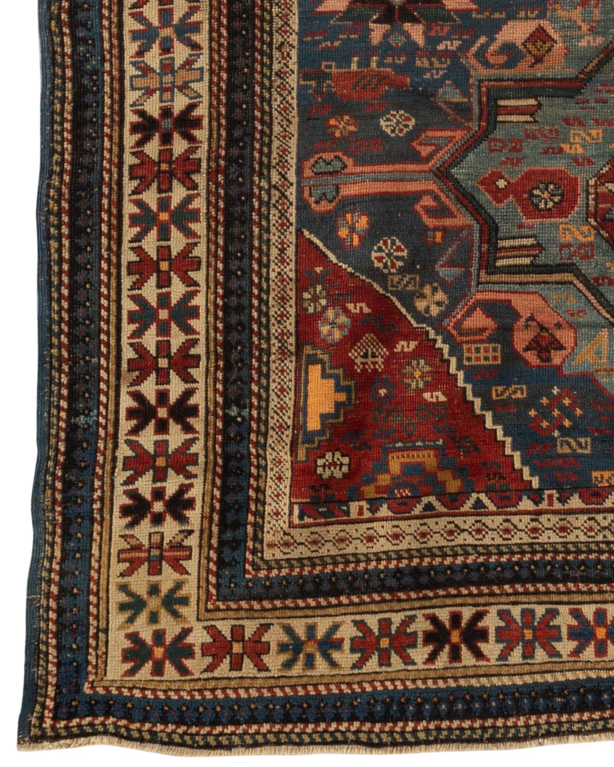 Antique Caucasian Shirvan rug, circa 1880. The field of soft blues with three central motifs all filled with floral and ethnic designs and enclosed within the typical Caucasian multi borders. These types of antique Caucasian rugs were woven in the