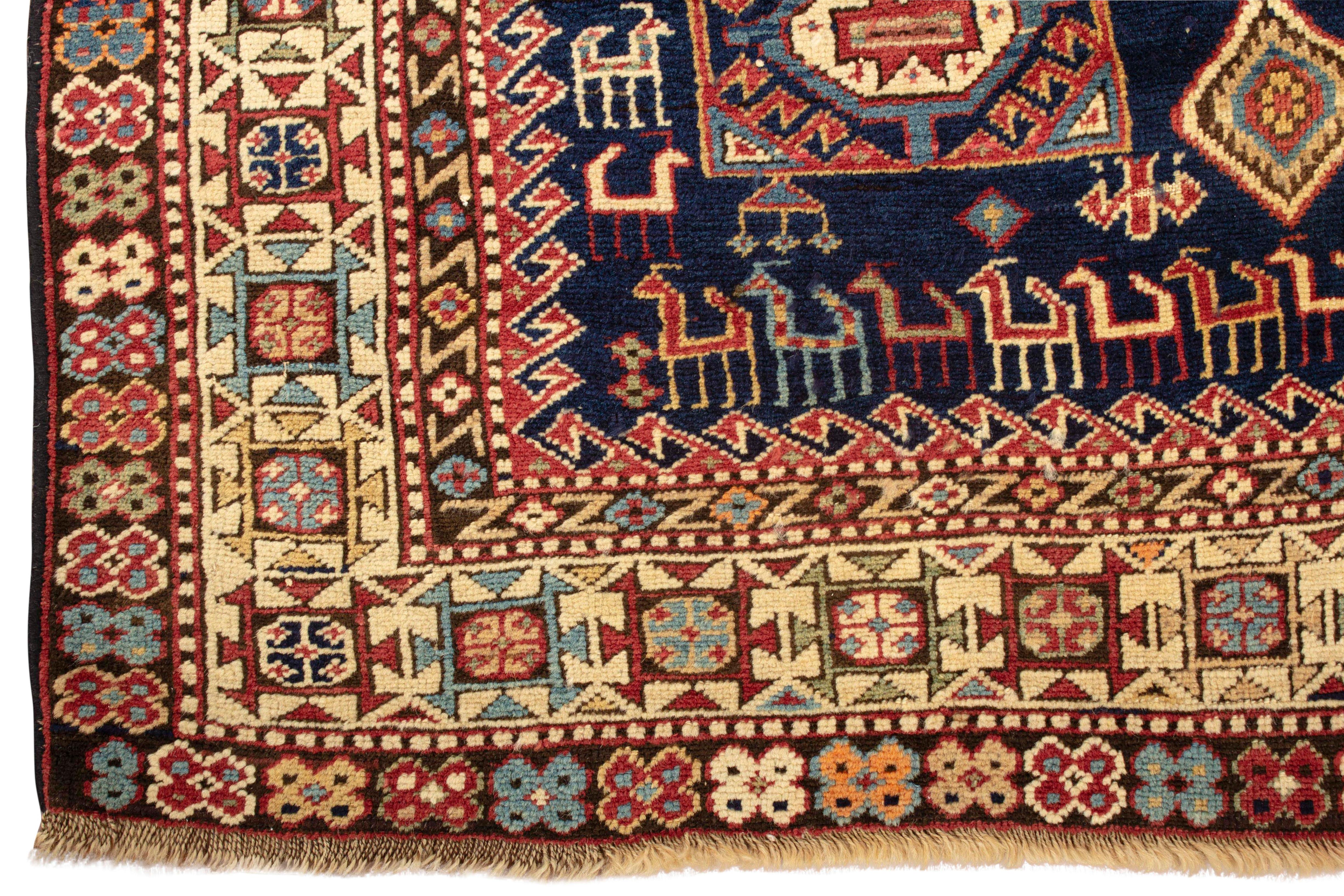 Antique Caucasian Shirvan rug, circa 1880. These types of antique Caucasian rugs were woven in the eastern part of the region, mostly along the west coast of the Caspian Sea. The wonderful main field with two diamond lozenges on a navy ground filled