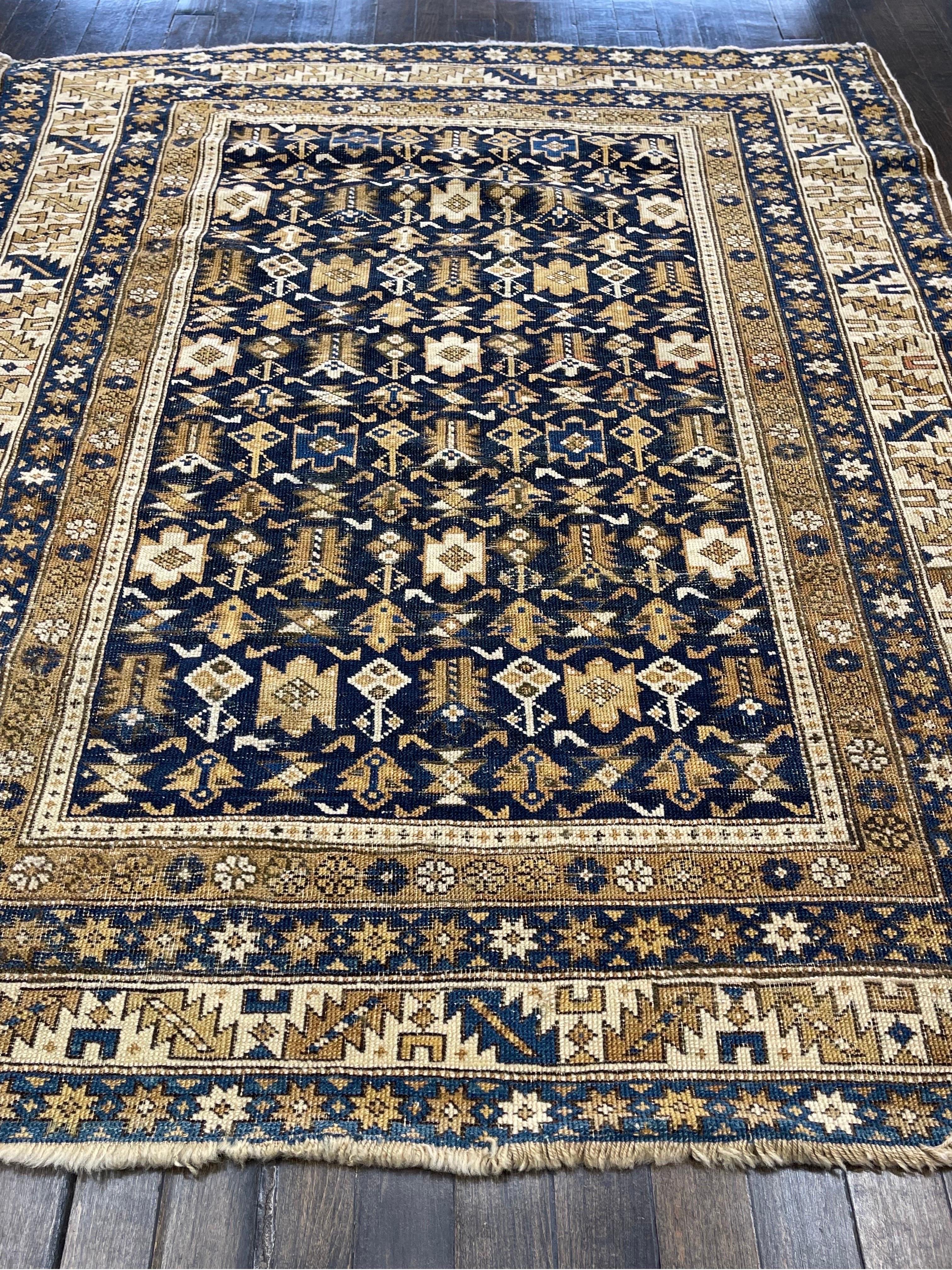 Extremely tight knotted carpet,this rug was made in the town of Shirvan located in the caucasus mountains.The field has shrub- like flowers arranged with a lattice on an indigo blue ground.

The very unusual six guard borders frame the rug nicely