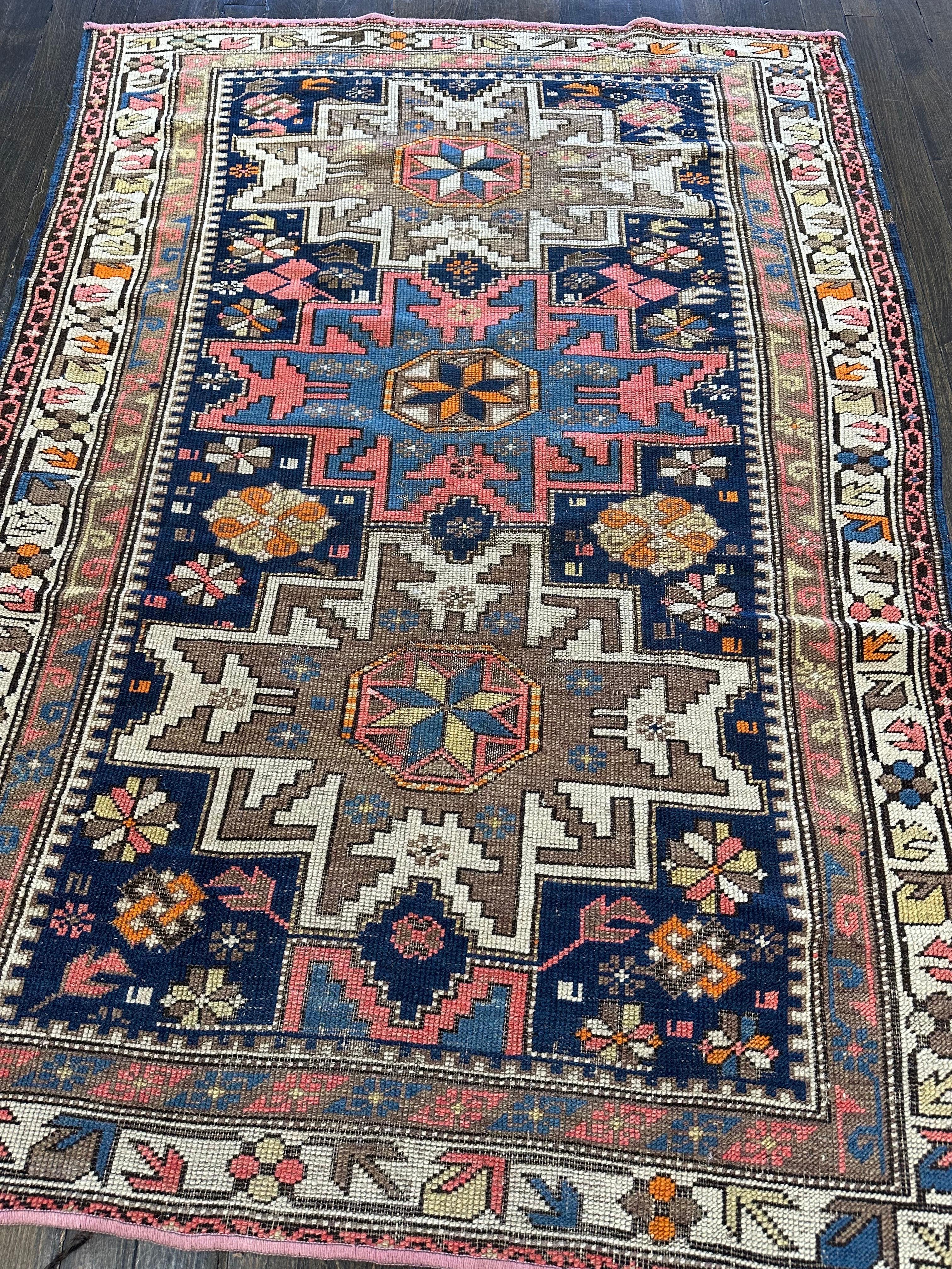 Great looking antique Caucasian Shirvan featuring an indigo blue field decorated with three star medallions, two in ivory and tan and the middle one with sky blue and pale orange colors. These twelve pointed stars with stepped outlines known as