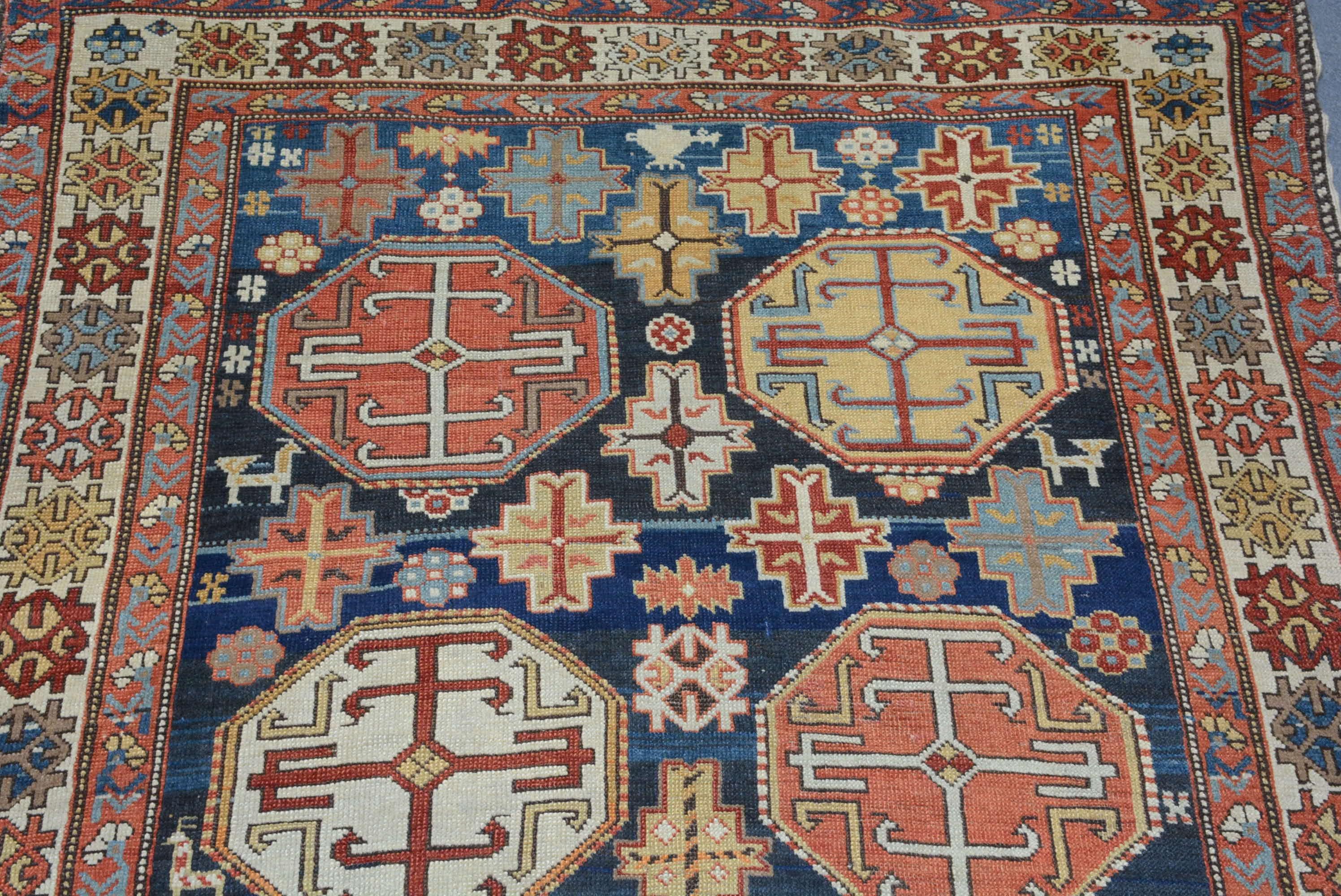 The Shirvan region in the eastern Caucasus is one of the principle weaving centers in that region.  This area is known for producing bold geometric patterns executed in primary colors.  This rug has two columns of octagonal medallions on an indigo