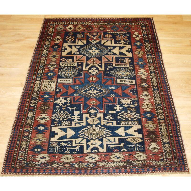 Antique Caucasian Shirvan rug with 'Lesghi star' design.

A superb Caucasian rug with a single vertical row of three 'Lesghi Stars', Superb colour and fine Shirvan like weave. The border is of note with the unusual white box half way up on the