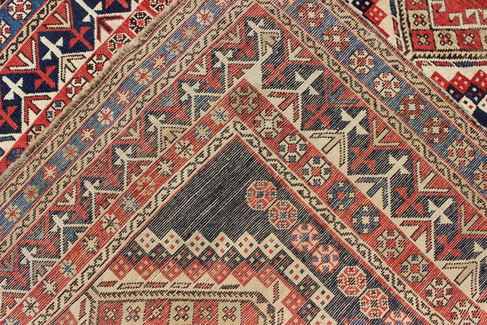 Wool Antique Caucasian Shirvan Rug with Tribal Design and Medallions For Sale