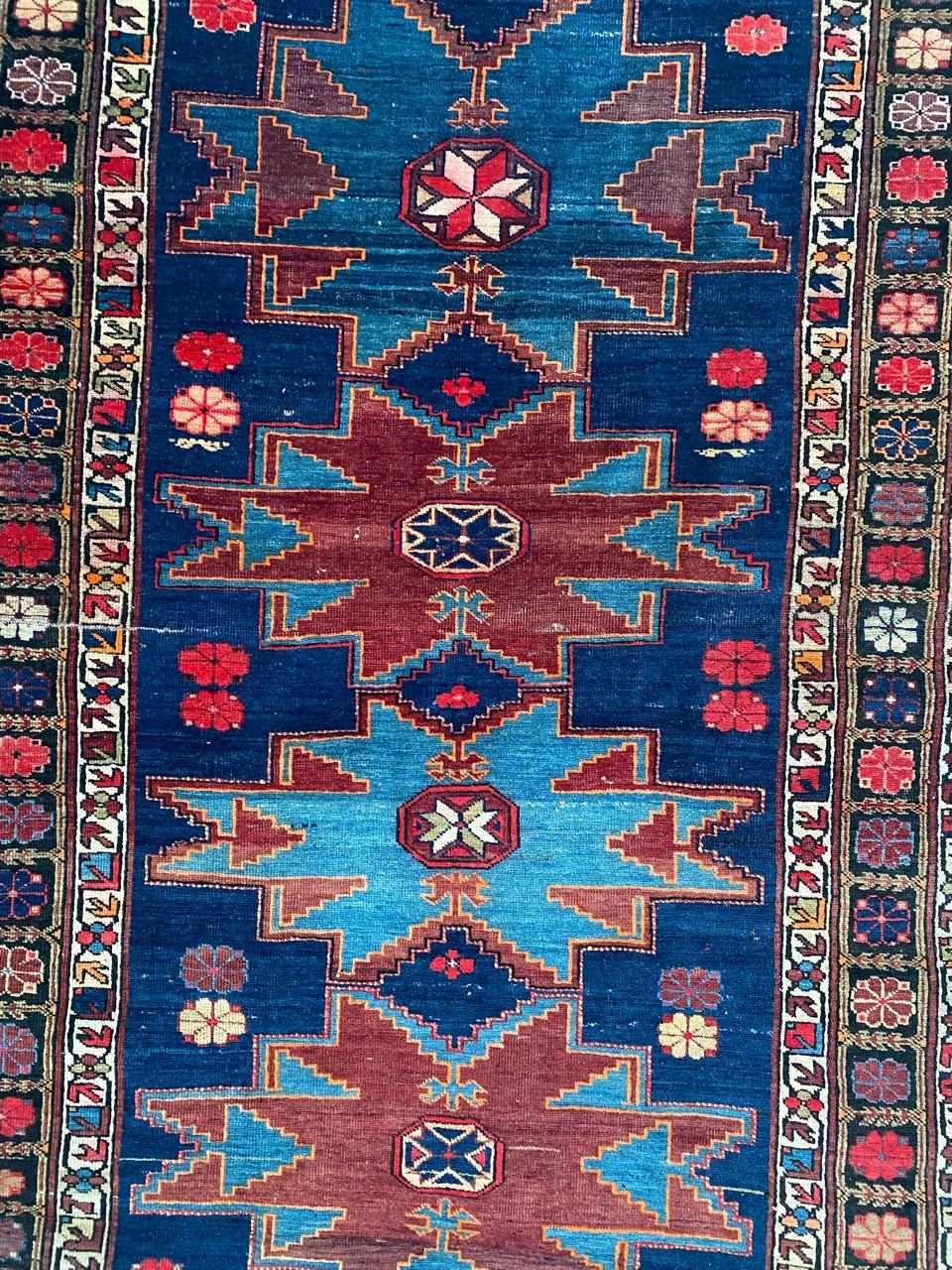 Discover the exquisite craftsmanship of this early 20th-century Caucasian Shirwan rug. Adorned with a captivating geometrical design and stunning natural colors, this rug is a testament to meticulous hand-knotting using wool velvet on a wool