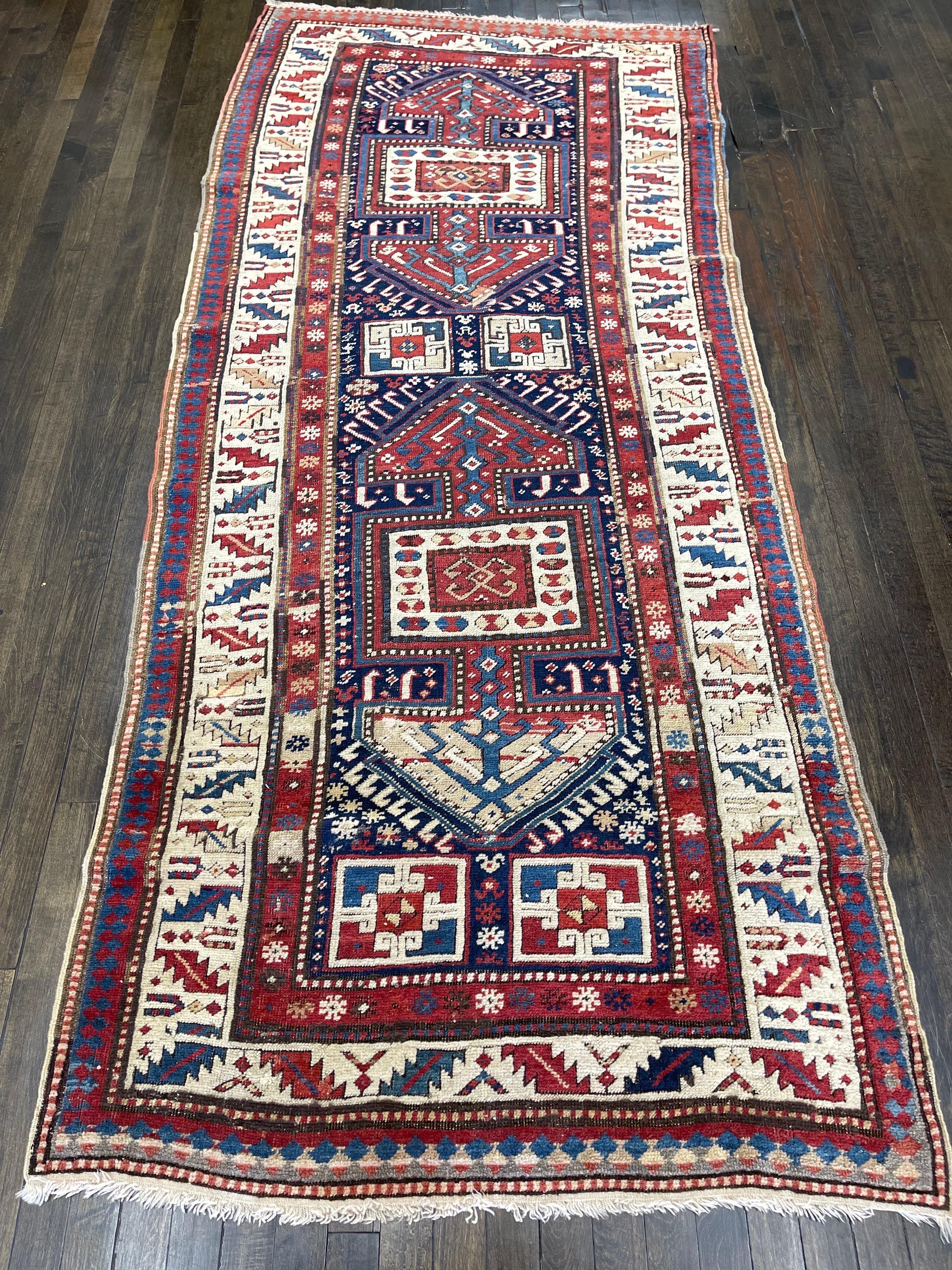 A bold and handsome example of the Surahani Baku garden design, this rug was handwoven in the Caucasus mountains, perhaps in the east central region. 

With brilliant colors of reds, blues, green and ivory this rug would have a visible presence in
