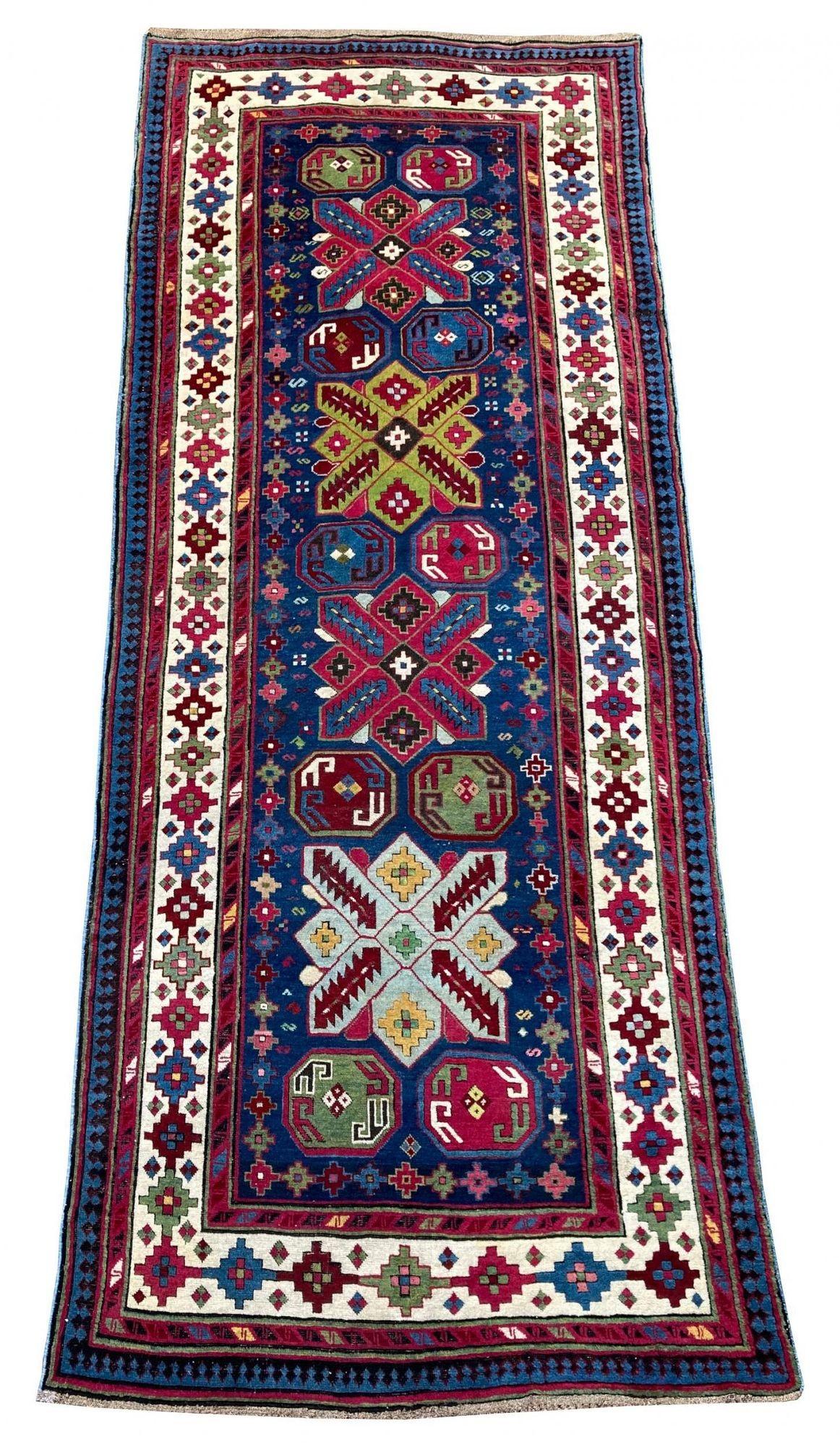 An exceptional Caucasian runner, hand woven in the Talish region of Azerbaijan circa 1900 with a geometrical design on an indigo field and ivory border. A highly collectible rug with fabulous wool quality and stunning secondary colours.
Size: 2.97m
