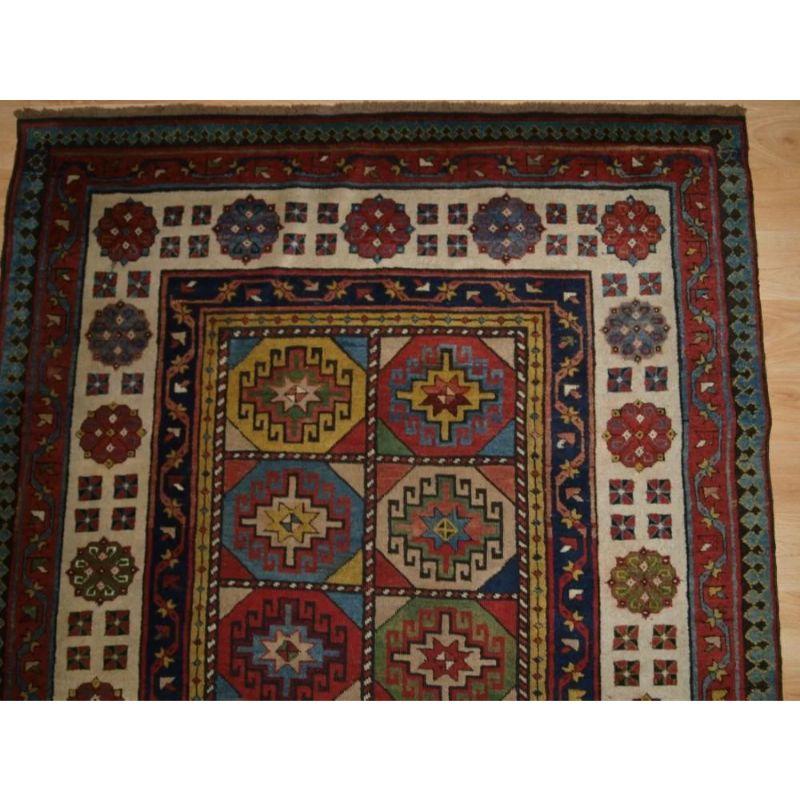 A superb example of a Talish long rug from the second half of the 19th century. The rug has multi-coloured memling guls in compartmented boxes framed by a classic Talish border on an ivory ground. The mustard yellow is really superb. The rug is of a