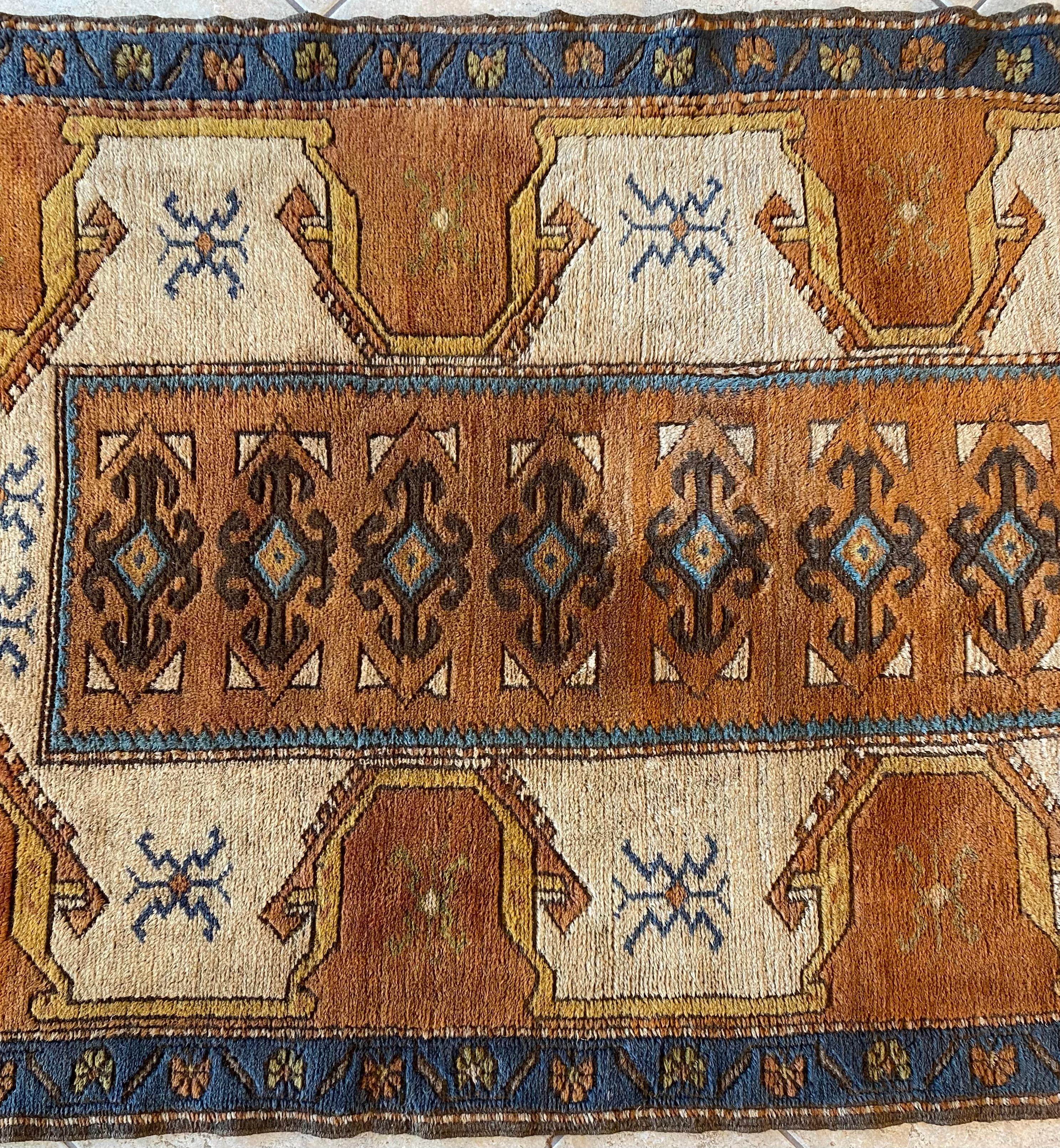 Antique Caucasian Kazak Hallway Runner with Tribal Style and subtle earth tones. 

Bearing traditional designs from the Caucasus region, this hand-knotted wool Antique Caucasian Kazak Hallway Runner with Tribal Style features an array of medallions