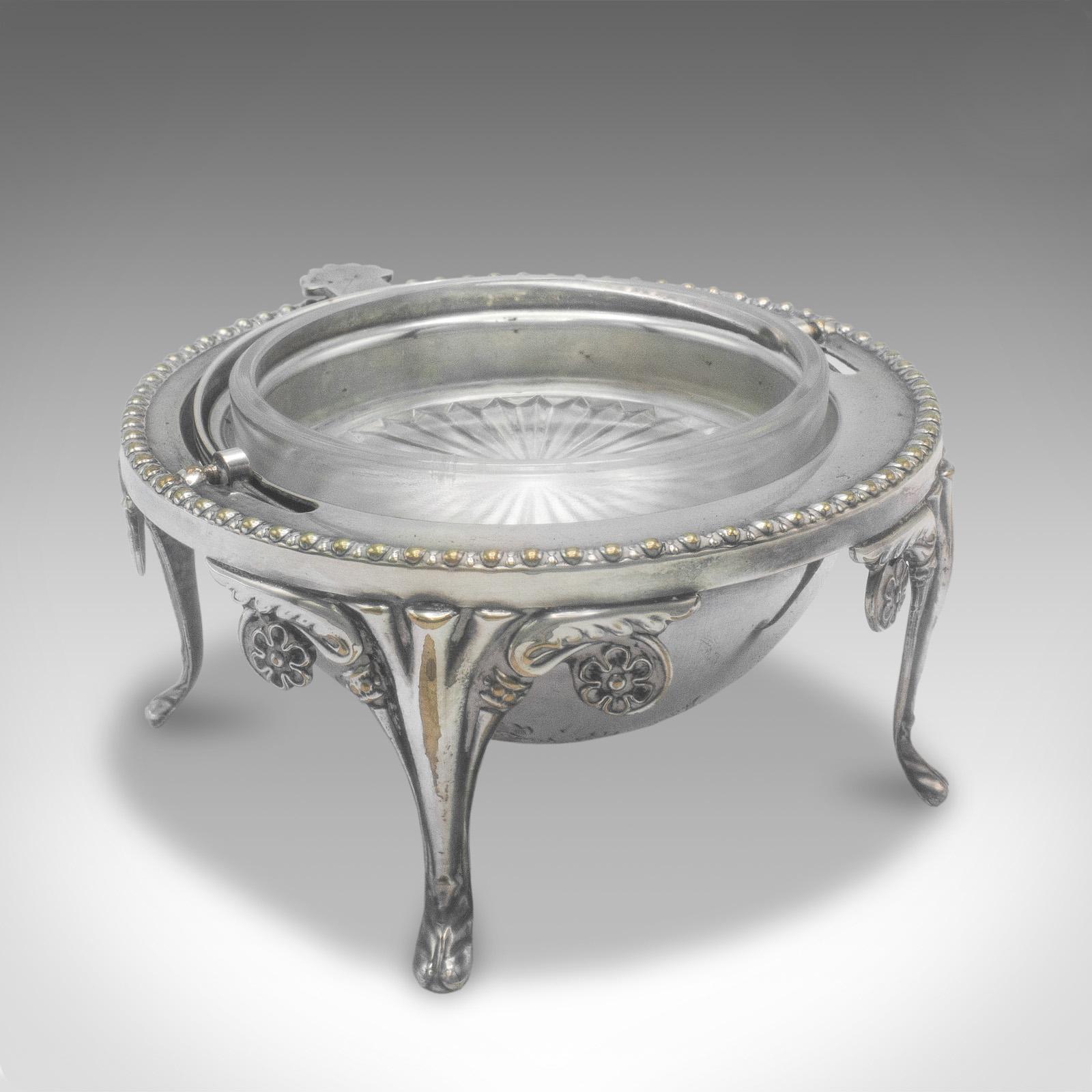 
This is an antique caviar dome. An English, silver plate and glass lidded serving bowl, dating to the Edwardian period, circa 1910.

Delightful serving dome with a charming engraved finish
Displays a desirable aged patina and in good original