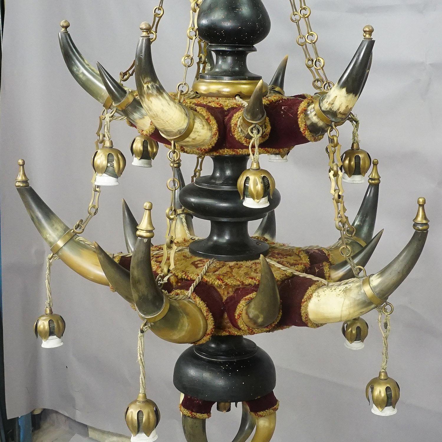 Antique ceiling lamp with cattle horns, Austria, circa 1880

A rare rustic ceiling lamp made of original bull or cattle horns, wood, brass chains and fittings and velvet fabric. Manufactured in Austria ca. 1880. An extraordinary addition to each