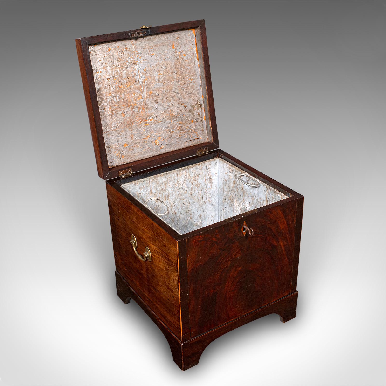 This is an antique cellarette. An English, mahogany wine cellar or fireside store, dating to the Georgian period, circa 1780.

Superb storage piece, with fine Georgian craftsmanship
Displays a desirable aged patina and in good order
Select stocks