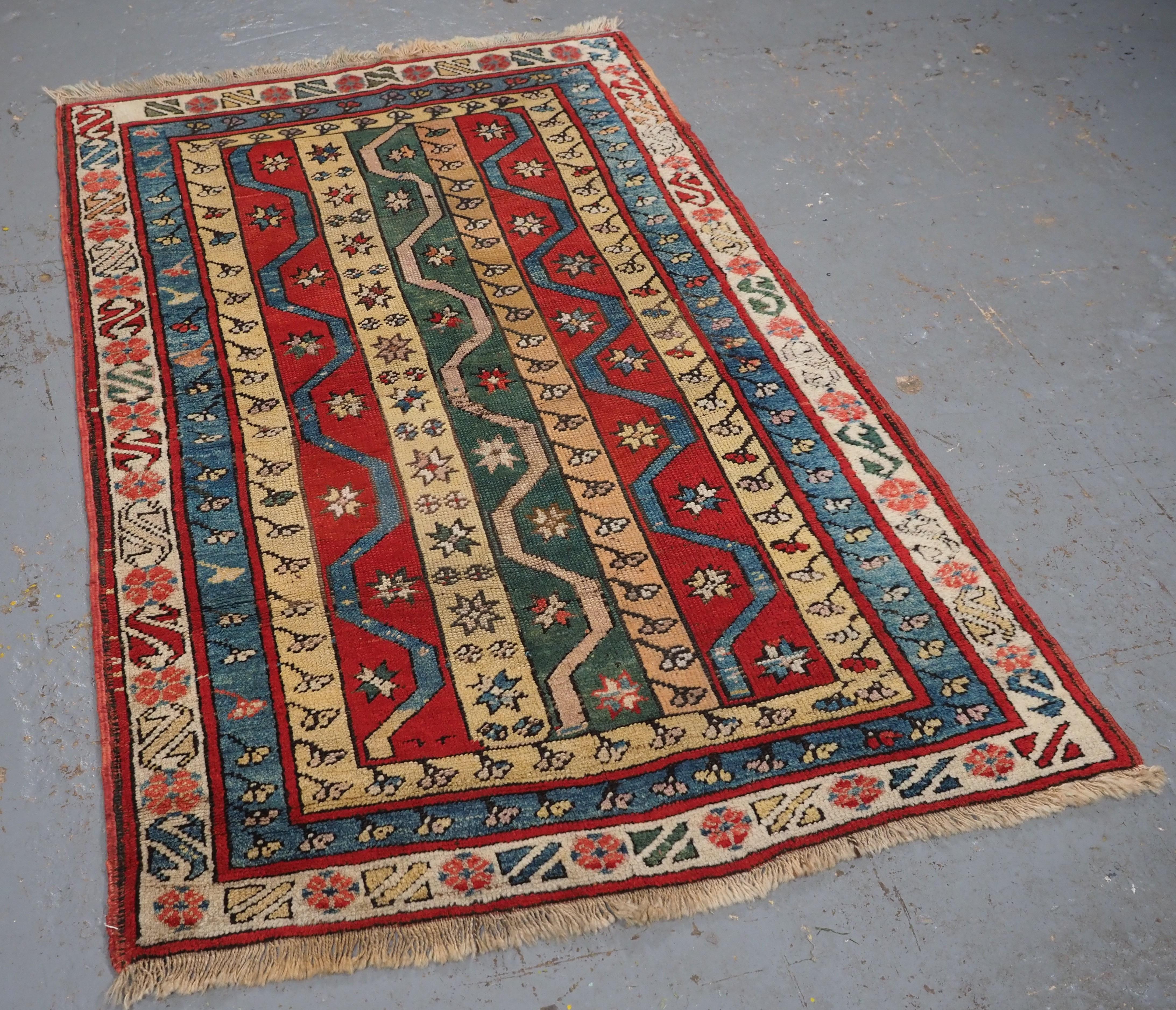 Size: 5ft 7in x 3ft 7in (170 x 108cm).

Antique Central Anatolian Konya region village rug.

Circa 1900/20.

A nice small example of a Konya village rug with a classic design, the rug has a colourful stripe design with stars and carnation flowers.
