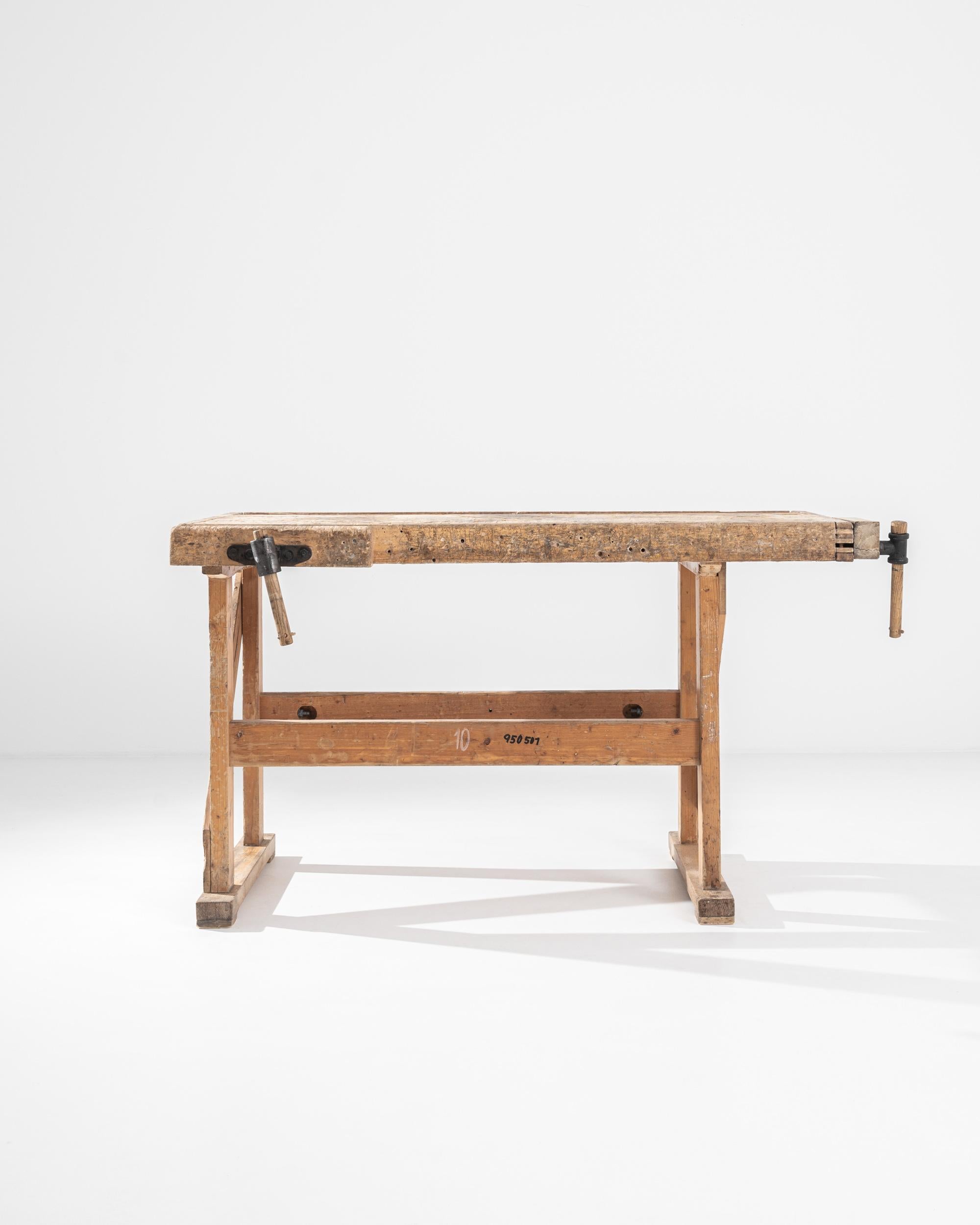 A vintage Central European wooden work table. Constructed from stout wooden beams, crafted with the owner’s livelihood in mind. This ultimate sturdy table’s newest craft is turning function into style. Worn and loved, the details in its construction