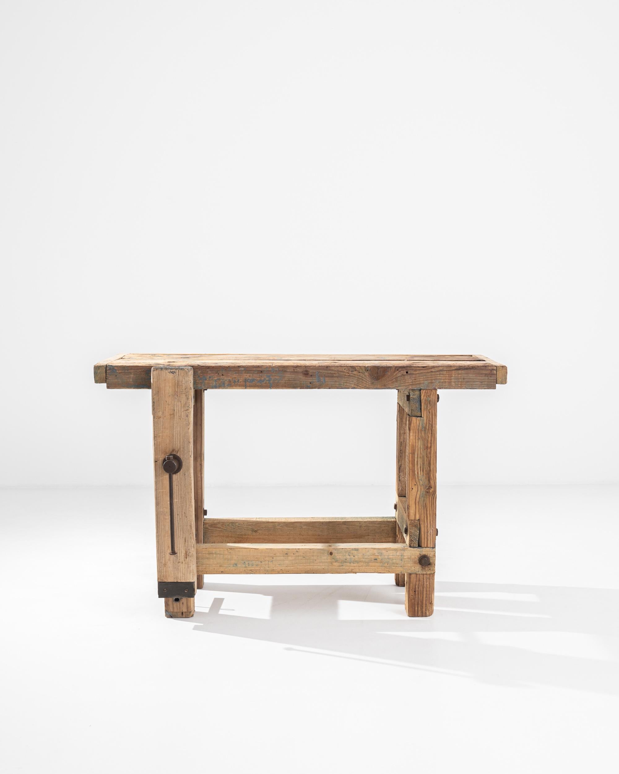 A Vintage Central European wooden work table. Constructed from stout wooden beams, crafted with the owner’s livelihood in mind. This ultimate sturdy table’s newest Craft is turning function into style. Worn and loved, the details in its construction