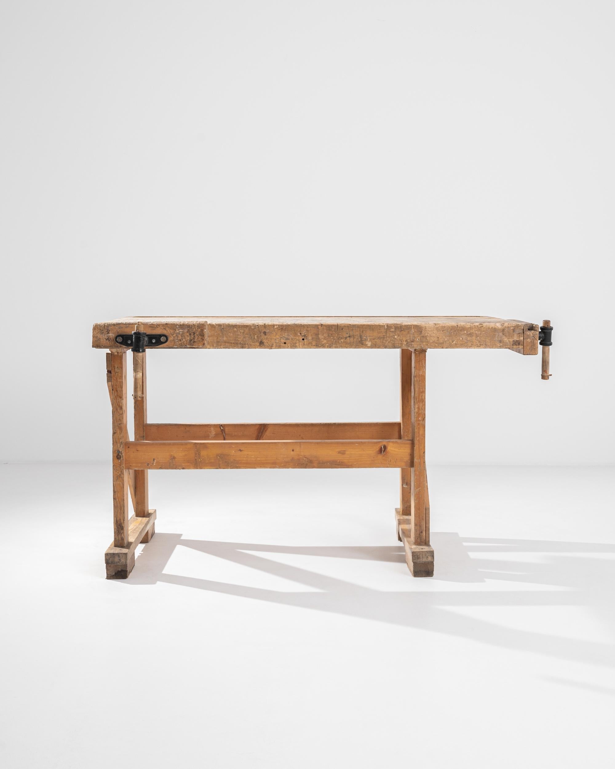 A vintage Central European wooden work table. Constructed from stout wooden beams, crafted with the owner’s livelihood in mind. This ultimate sturdy table’s newest craft is turning function into style. Worn and loved, the details in its