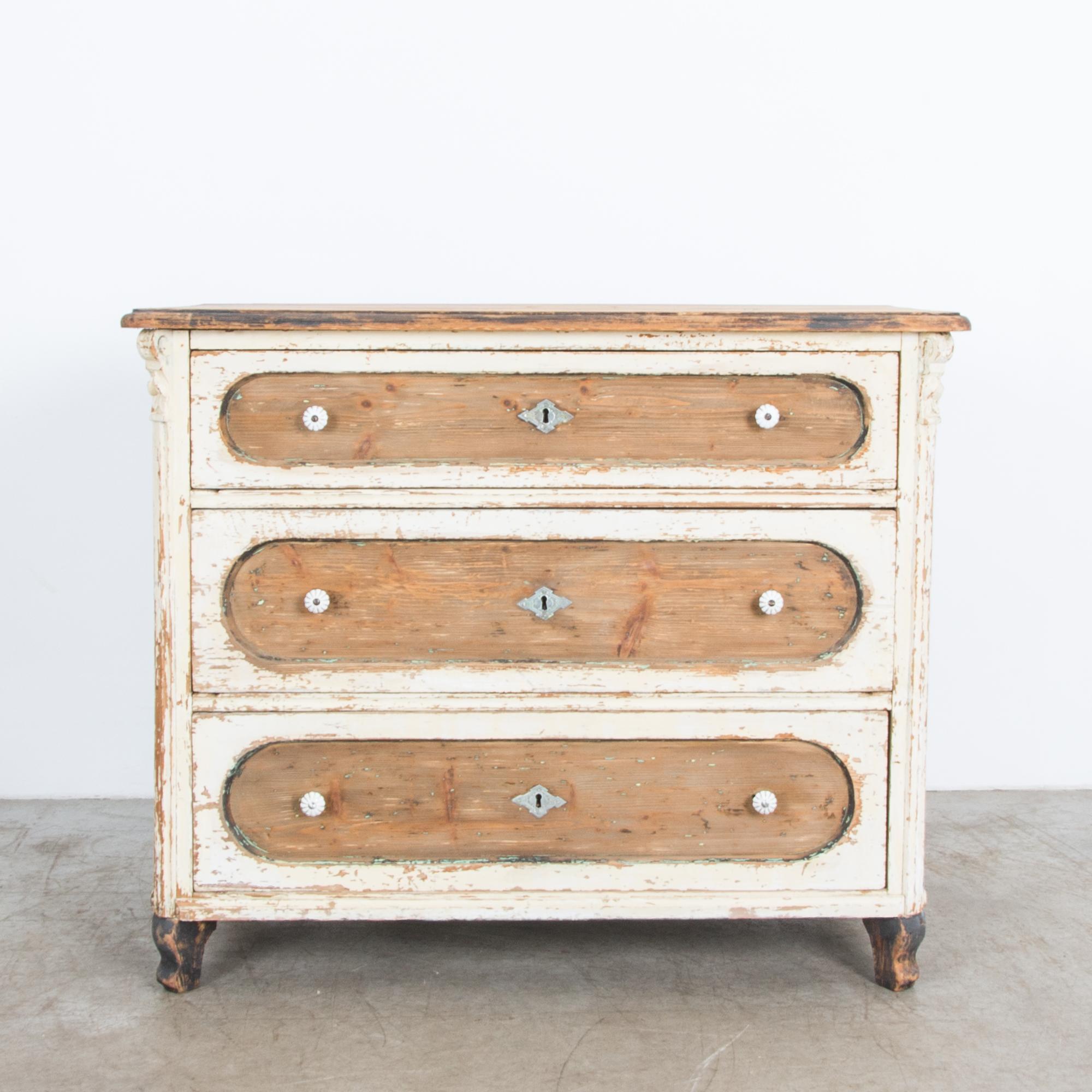 This three-drawer chest features a distinctive style from Central Europe. Bold rounded drawer fronts define this surprising geometric piece, complimenting the simple shape while subtly elevated with crafted details, figurative legs and a decorative