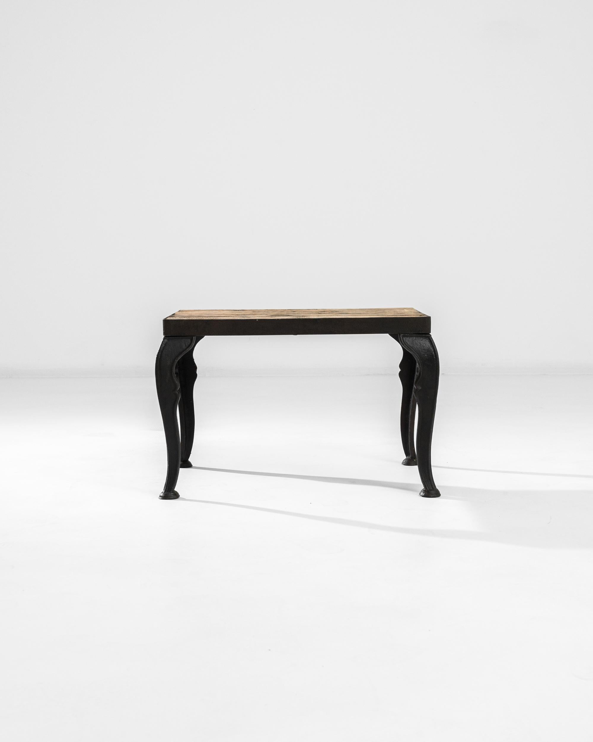 The unique design of this coffee table marries industrial and baroque aesthetics for a stimulating fusion. Made in Central Europe at the turn of the century, cabriole legs create a light and graceful silhouette, paradoxically realized in cast metal.