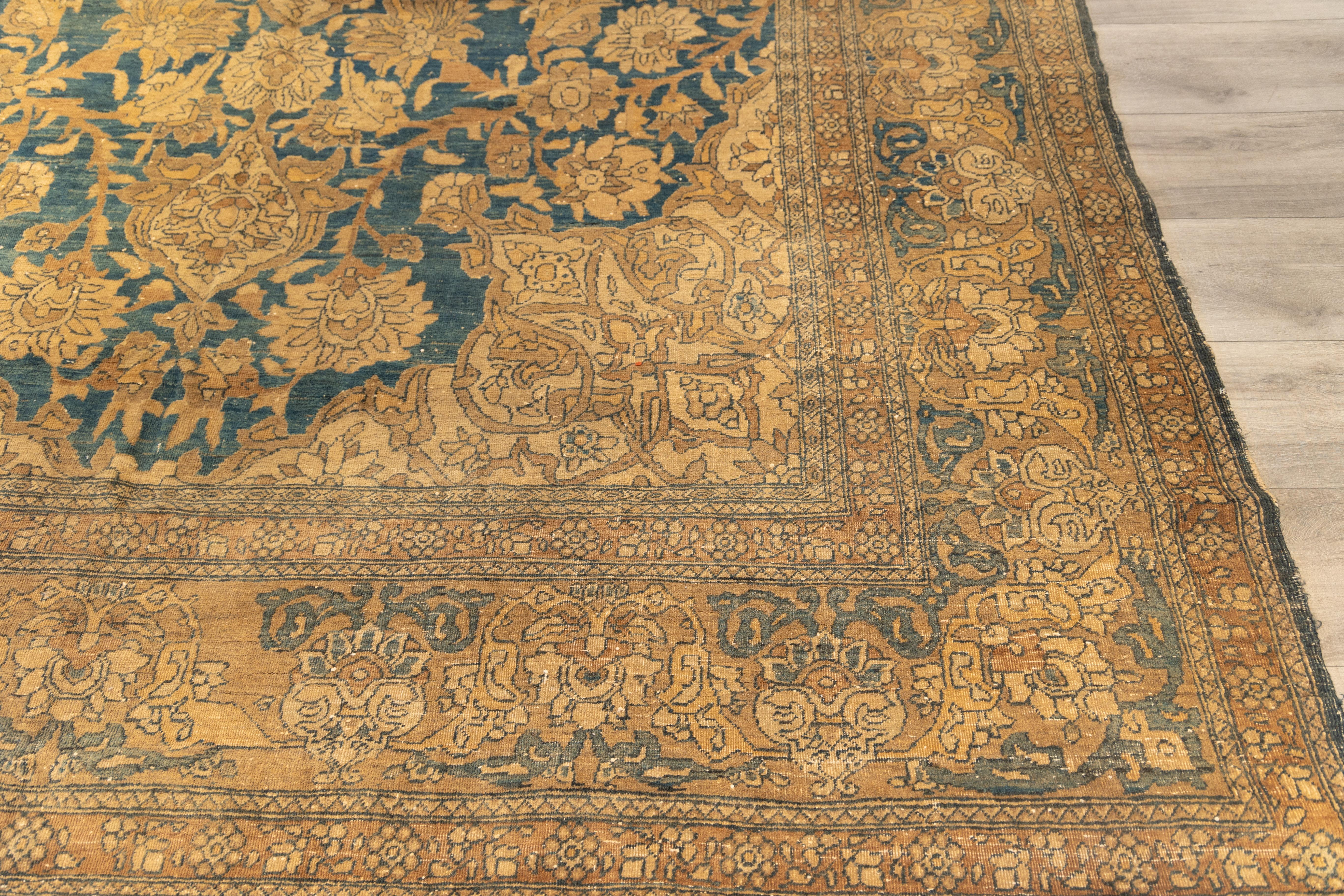 Antique Tabriz rug, likely from the early 20th century, 
large and desirable format.
raditional medallion-and-corner (medallion and spandrel) layout, a hallmark of classical Persian design. Faded midnight blue to teal field with strong abrash