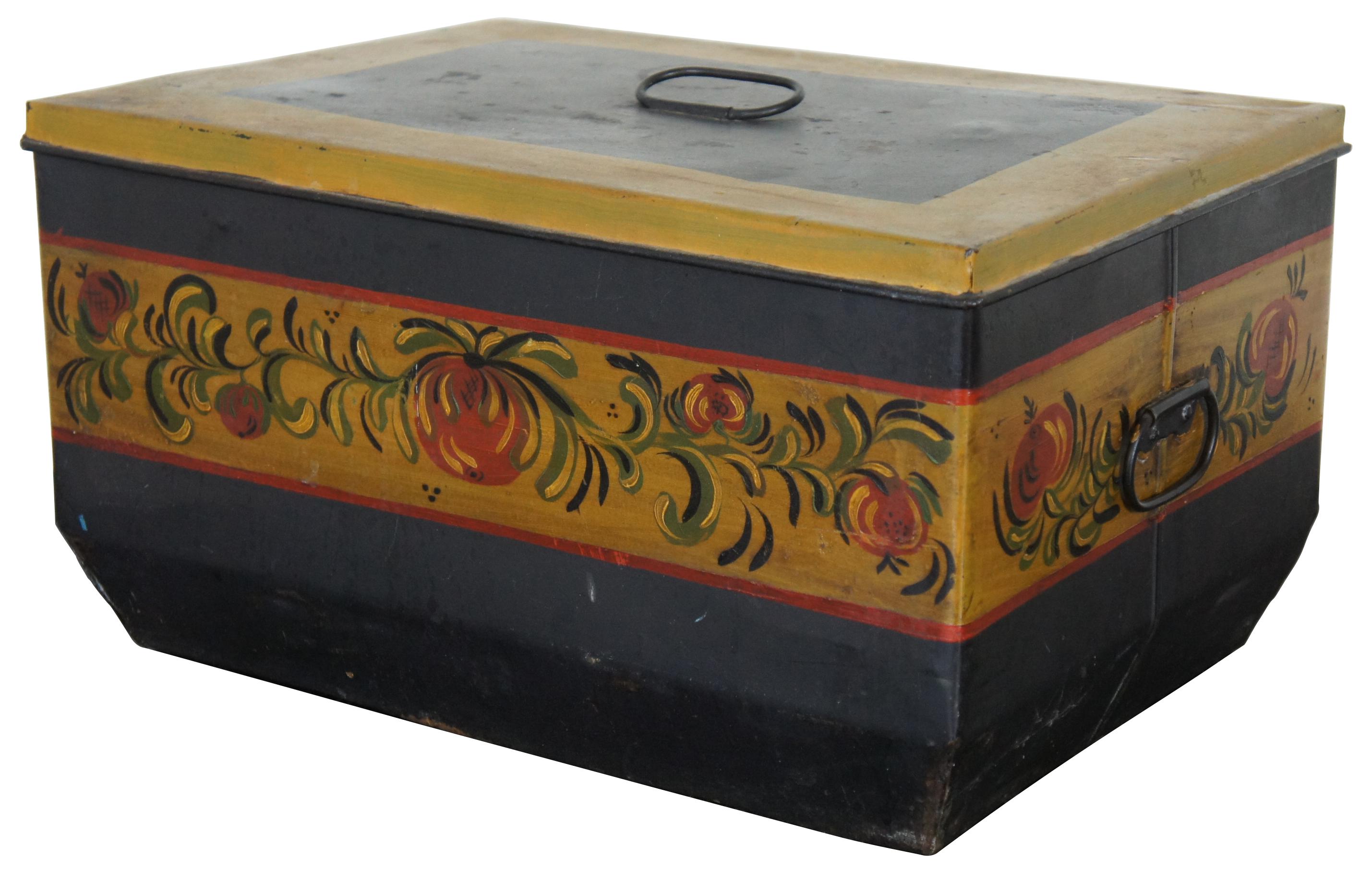 Antique painted toleware bread box by the Central Manufacturing Co, decorated with red tomatoes. The interior tray is removable and pierced with ventilation holes for airflow. 
 