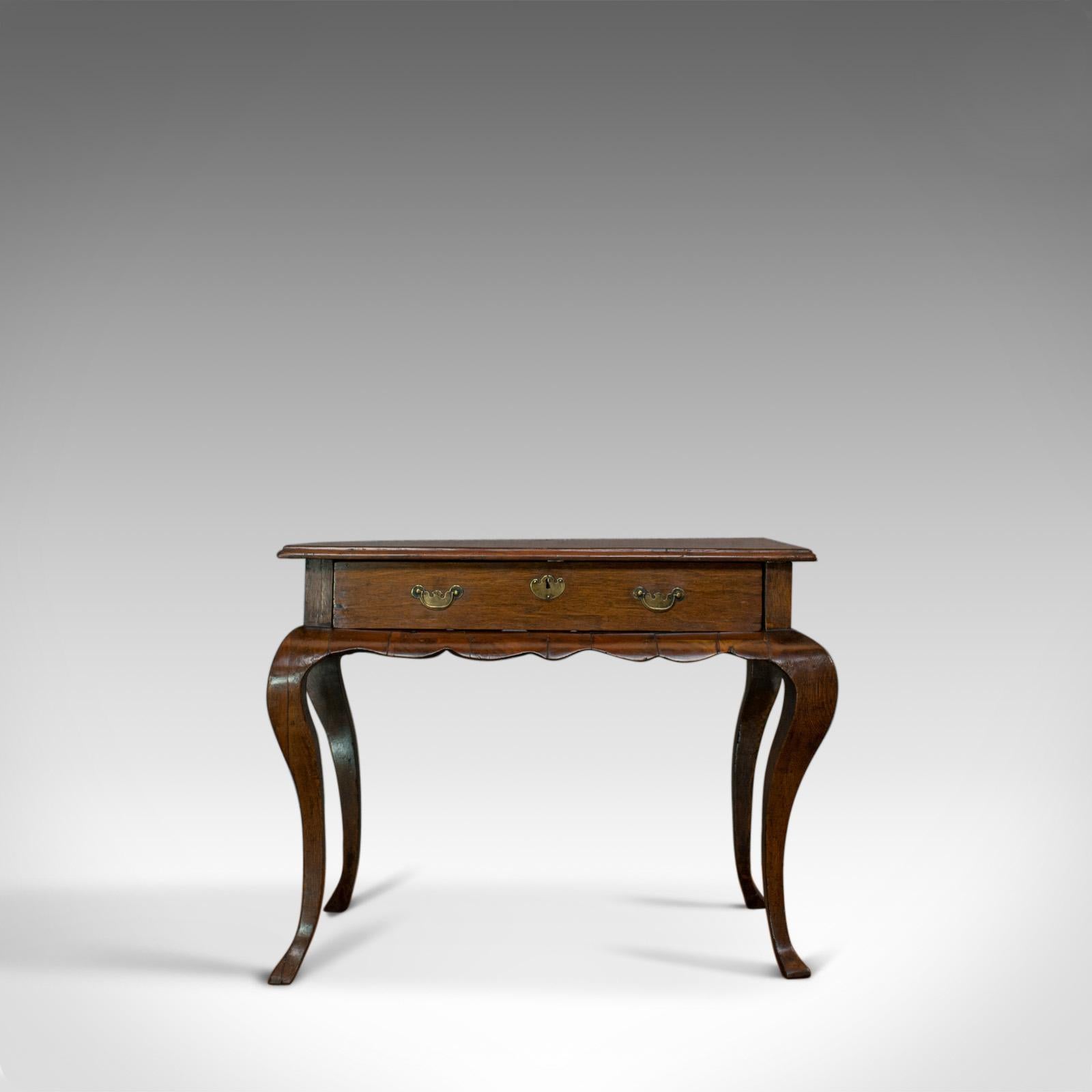This is an antique centre table. A Flemish, mahogany and oak occasional table of overt Dutch taste and dating to the late 18th century, circa 1800.

Attractive serpentine form in select cuts of mahogany and oak
Fine grain interest and a desirable