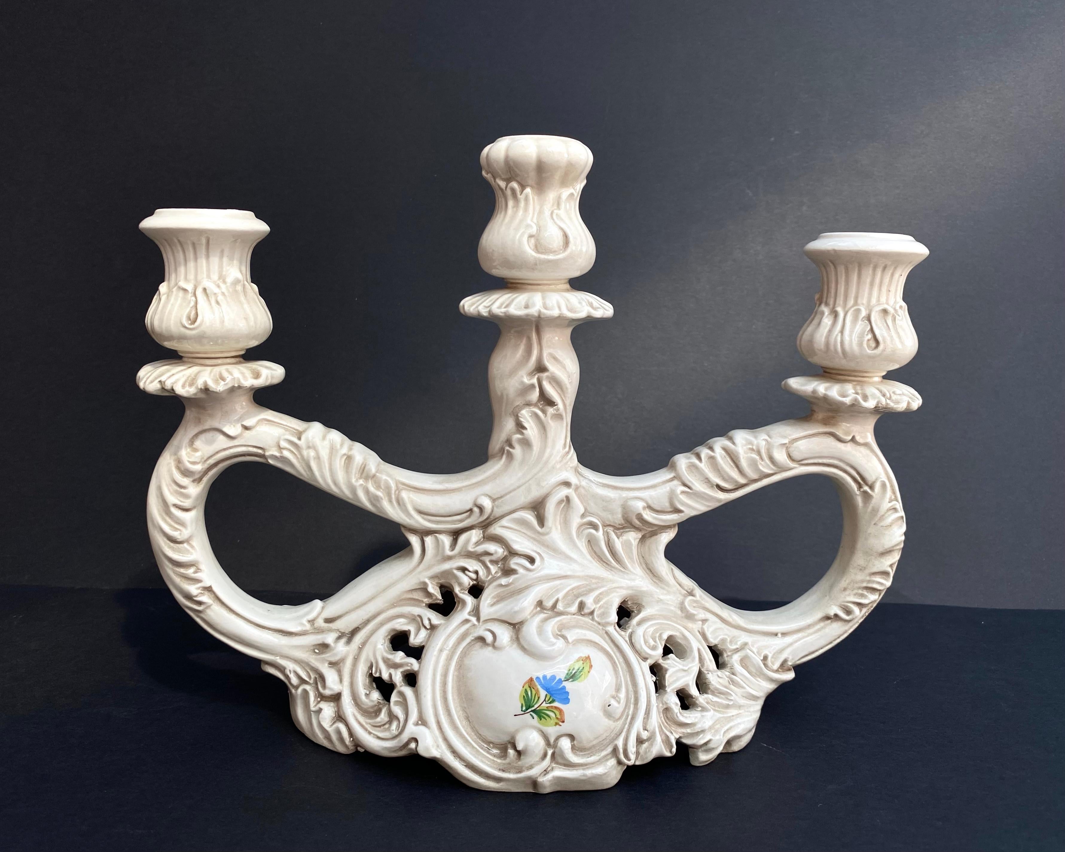 Wonderful hand painted candleholders with patina. Set 2.

Antique candleholder for three candles with floral decor by the Italian porcelain manufacturer.

Early 20th century.

The candle holders stamped on the bottom F.lli Bosello.

The