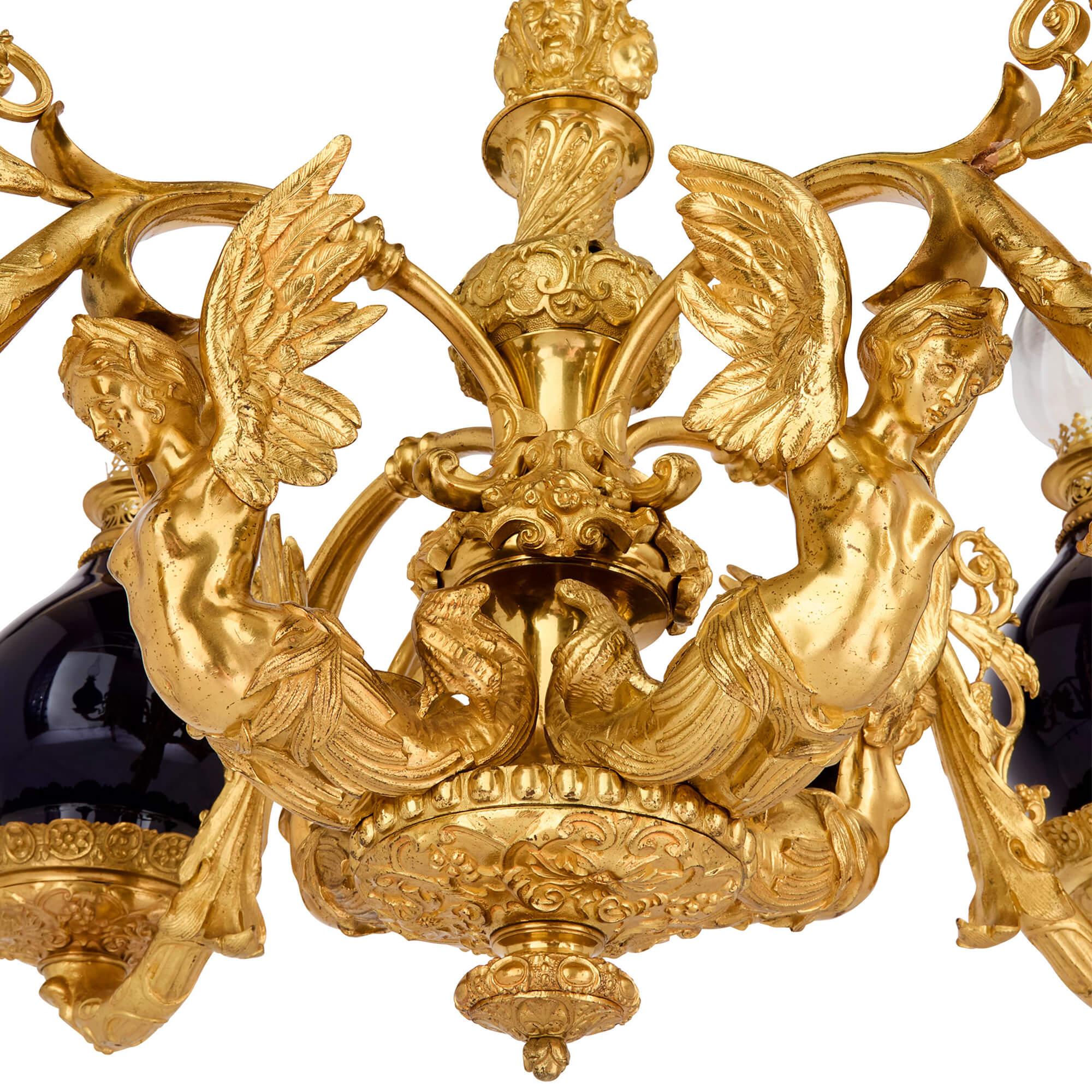 Antique ceramic, glass, and ormolu chandelier 
Continental, 19th Century  
Height 107cm, diameter 97cm 

This magnificent four-light chandelier showcases a fusion of design influences and is meticulously crafted from a selection of superb materials.