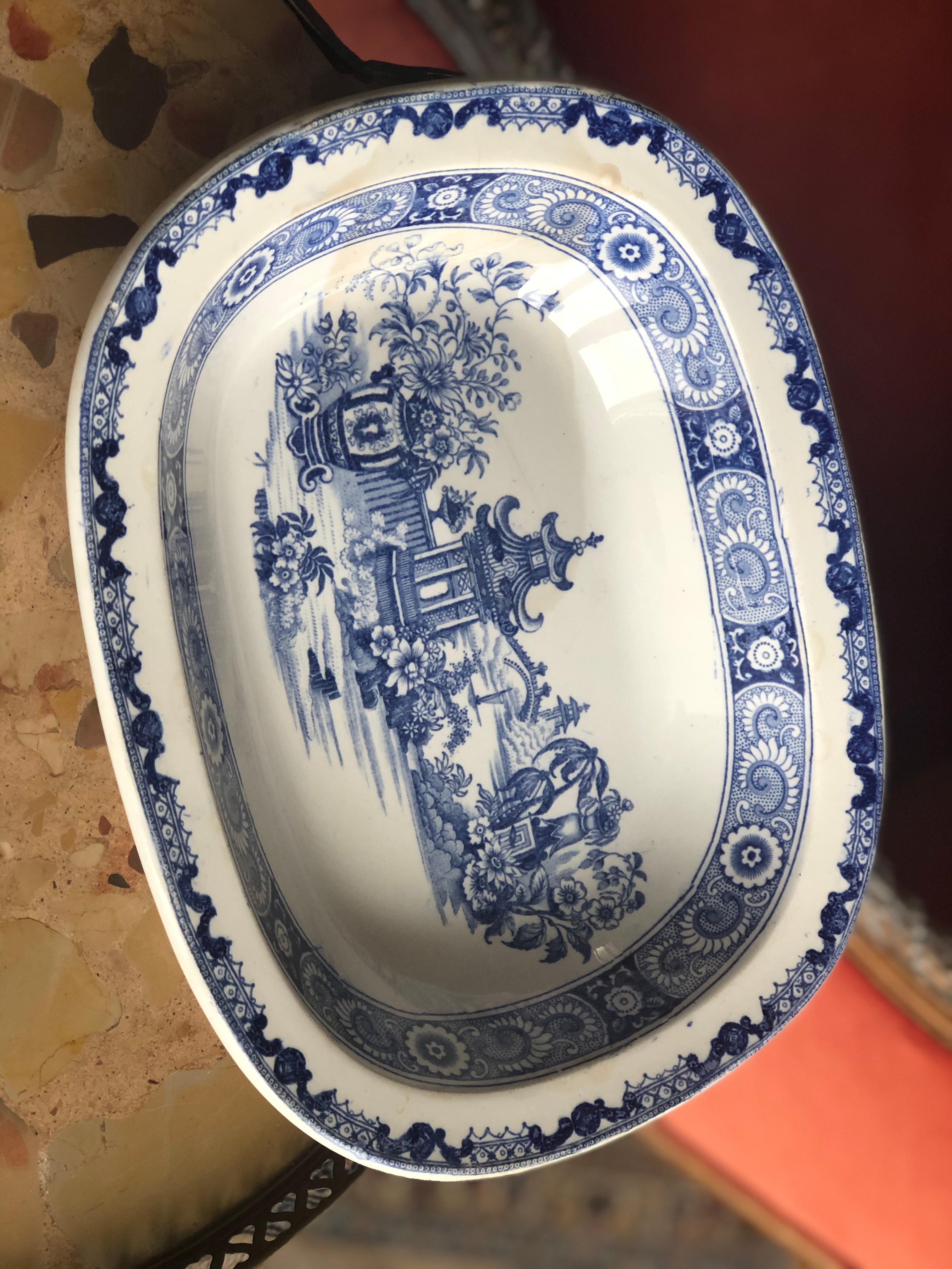 Oval antique ceramic plate with hand painted decorations in blue.
Restorations have been made.
  