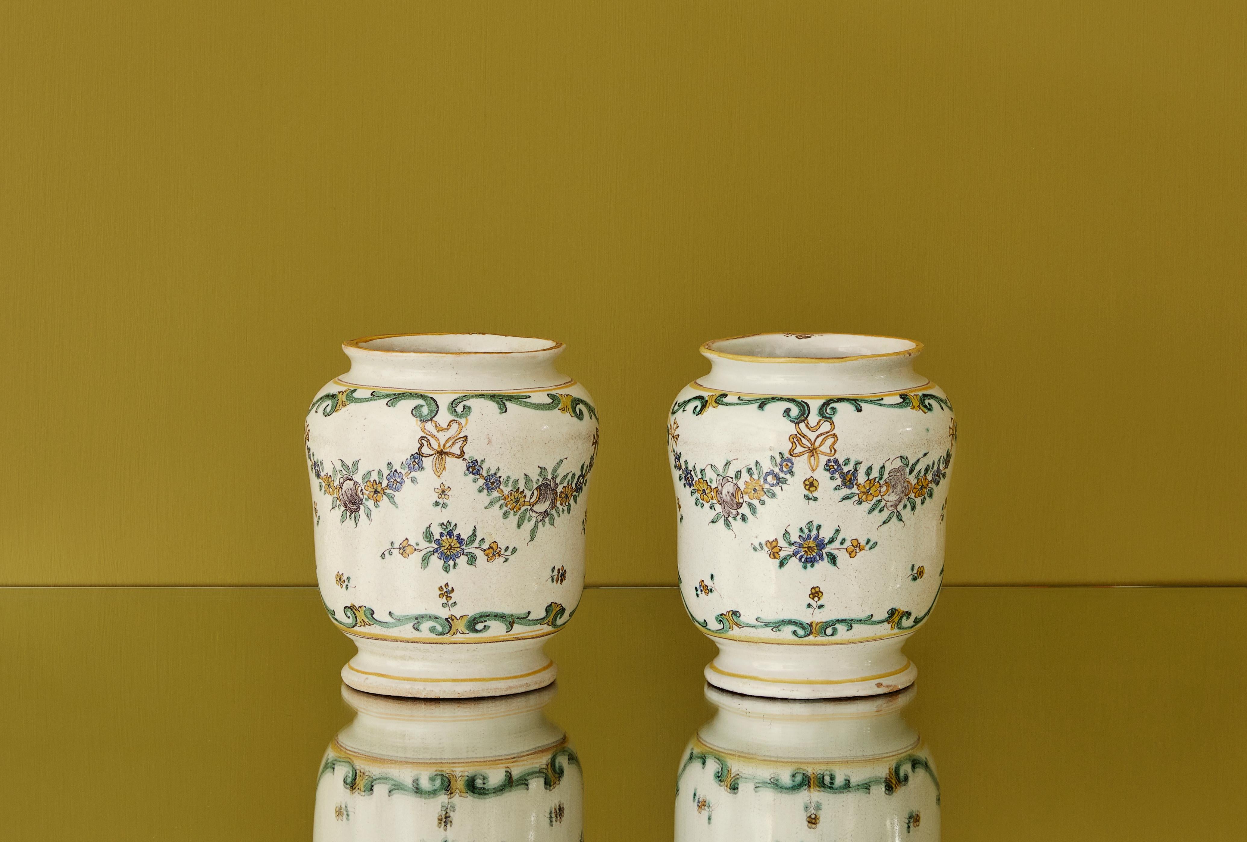 Italy, 19th century.

A pair of white ceramic vases with green and yellow flower decorations.

Measures: H 17.5 x Ø 14 cm.