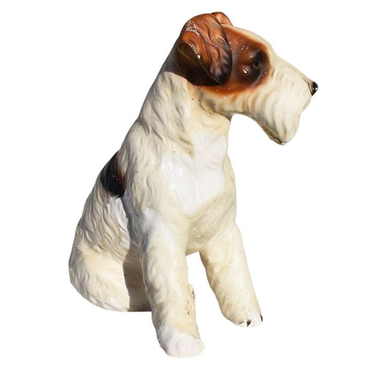 A seated ceramic terrier in brown, black, and white. This small statue will be adorable in a nursery or in a library. We suggest placing it on a bookshelf, or perhaps a side table. 

Dimensions:
9