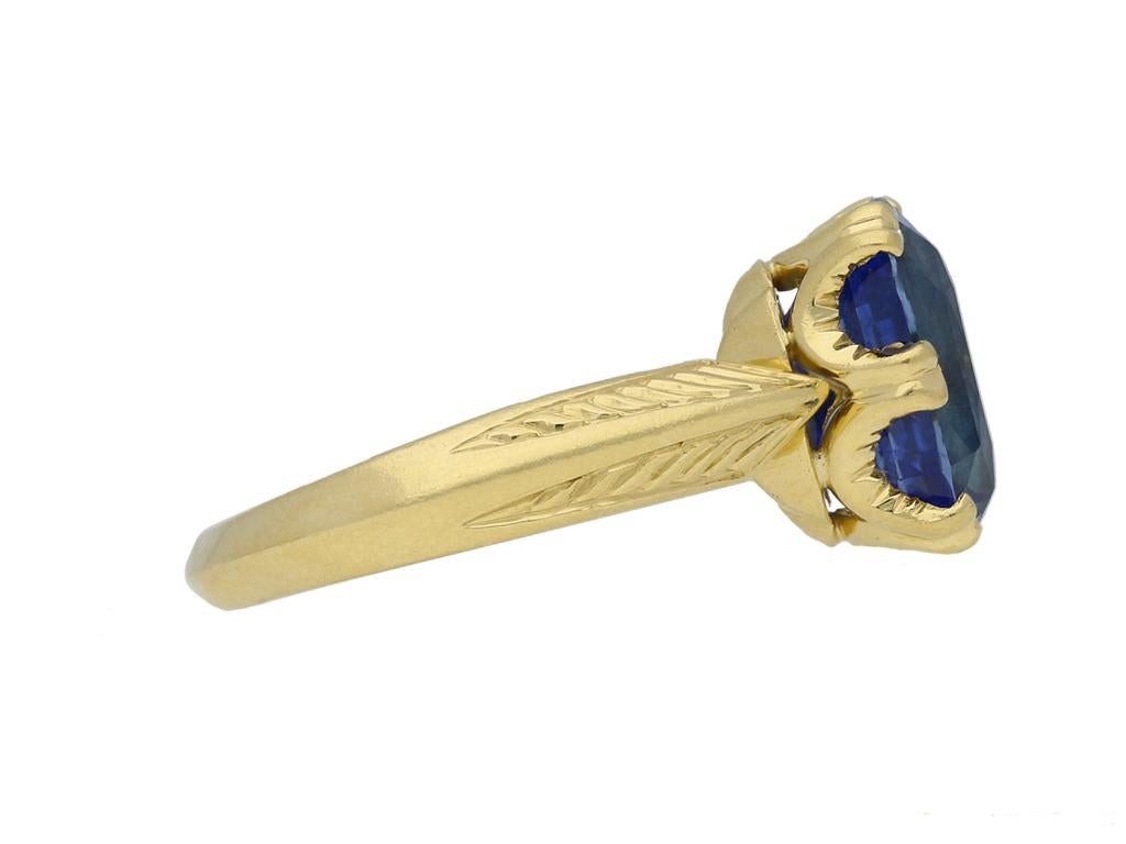 Antique Ceylon sapphire solitaire ring. Set with a cushion shape old cut natural unenhanced Ceylon sapphire in an open back claw setting with an approximate weight of 6.10 carats, to an elegant oval collet with split double claws, sweeping razored