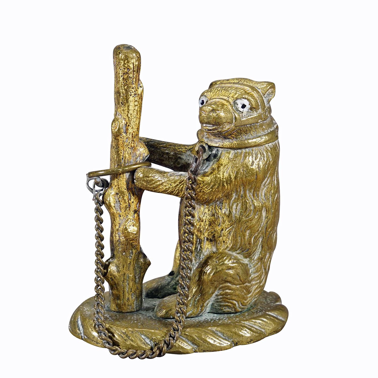 Antique Chained Bear Pillbox Made of Brass
Item e7255
A beautiful little brass statue of a bear chained to a tree stump. The bear's head can be opened. The figure can be used as a box for small items such as pills. Early 20th century. One eye is
