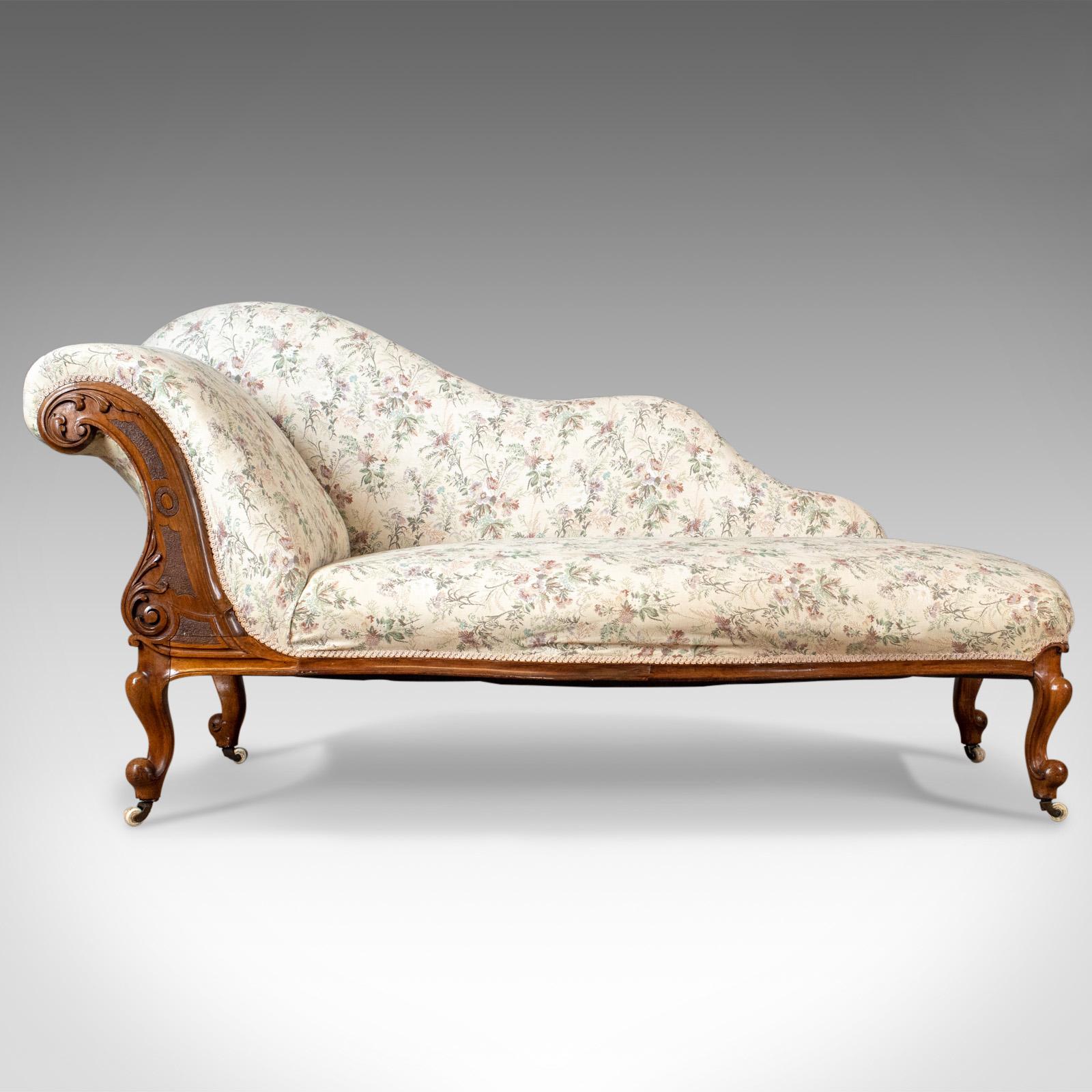 This is a left-handed antique chaise longue, an English, late Regency day bed on walnut frame dating to circa 1830.

Raised on walnut, cabriole legs with bump knee and toe
Riding upon the original ceramic castors
Appealing sinuous form,