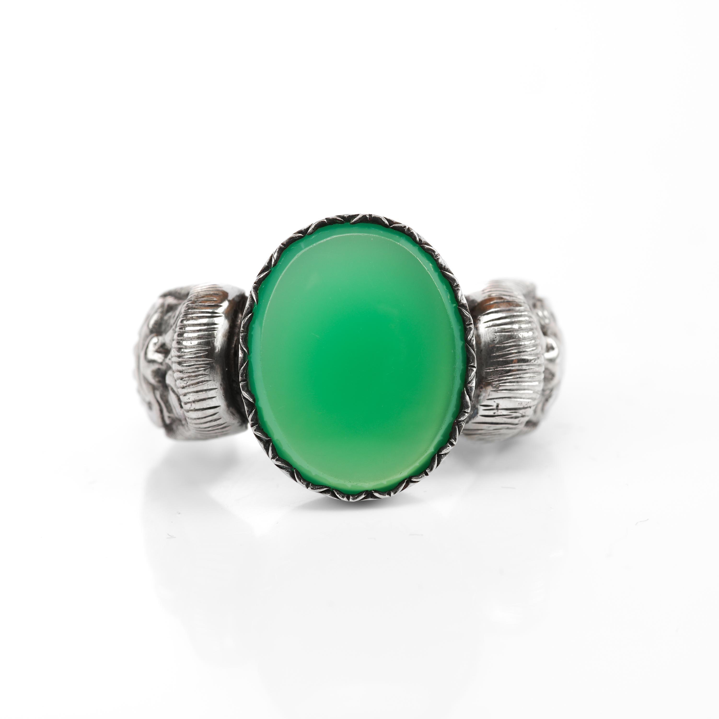 With what I believe to be a figural satyr on each shoulder, this blazingly unusual silver and green chalcedony ring is fronted with a lush buff-top and beveled-edged chalcedony gemstone. I have only seen one other ring even remotely similar to this