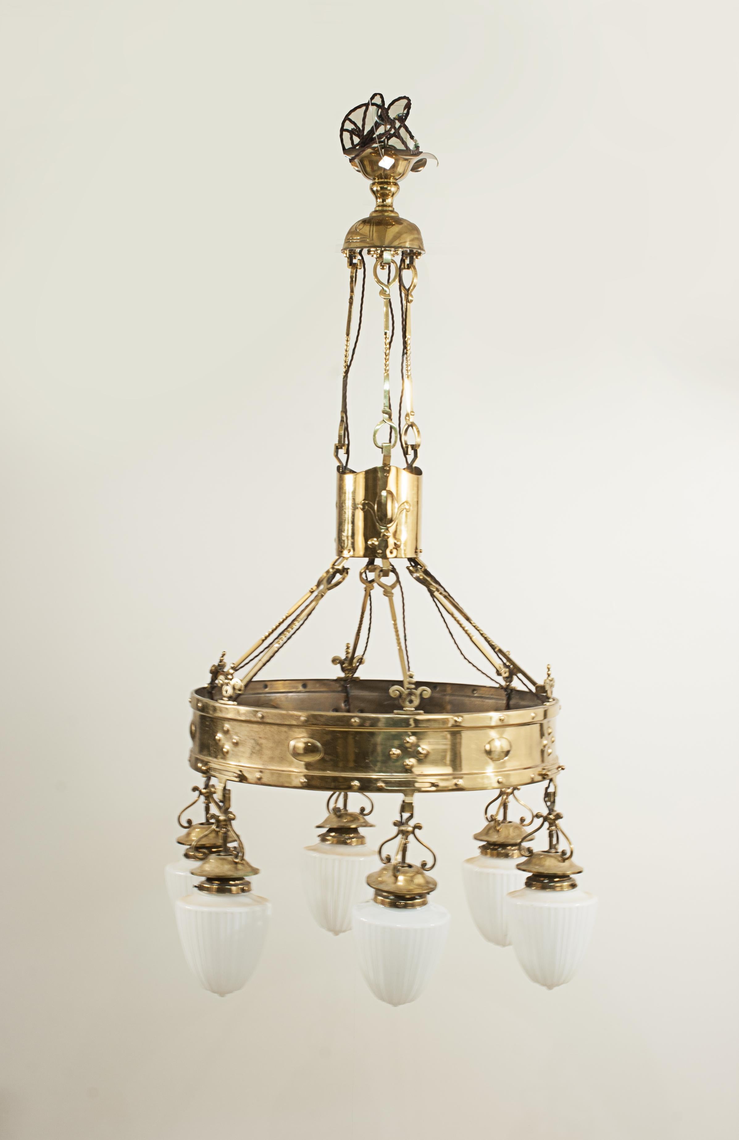 Arts & Crafts brass chandelier.
Edwardian Arts & Crafts elaborate brass six branch electrolier ceiling light. The Chandelier compromising of a large 66 cm brass band with six hanging light fittings, the fittings with the six original glass shades.