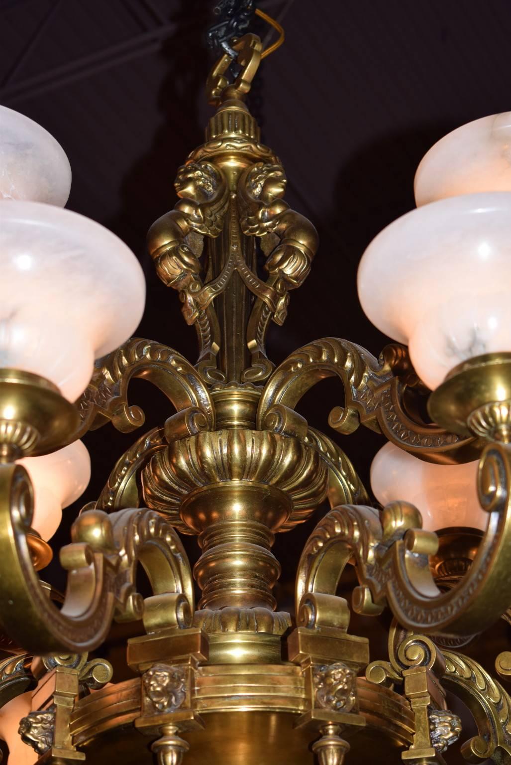 Elegant two-tiered bronze Regence style chandelier with alabaster shades, 12 lights.