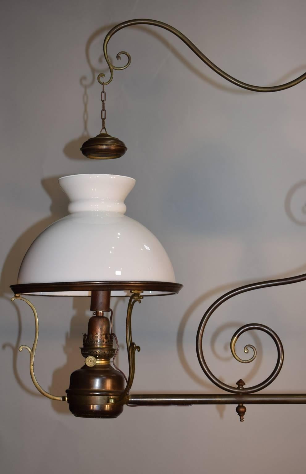 Fine two-light oil lamp with glass shades now converted to electric.