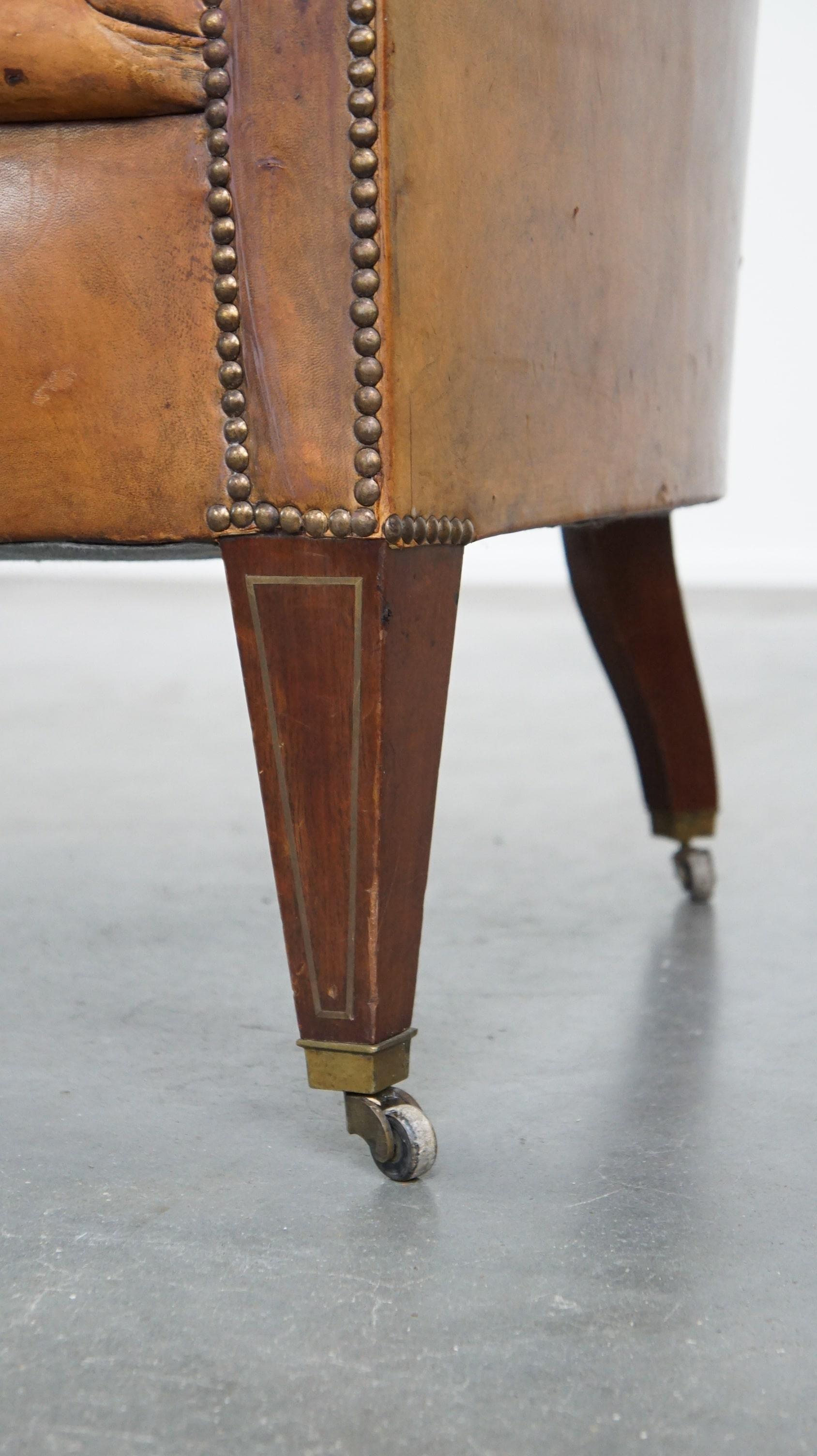 Antique, characteristic sheepskin chesterfield club chair on wheels For Sale 4